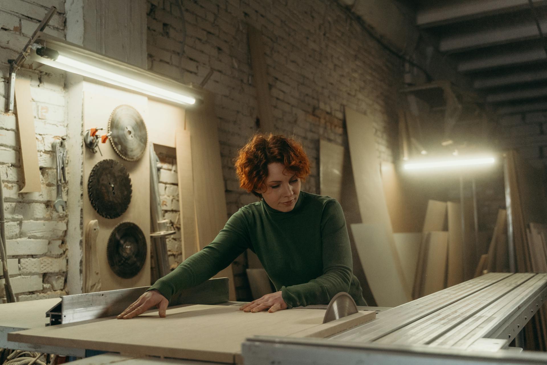 A woman sawing wood | Source: Pexels