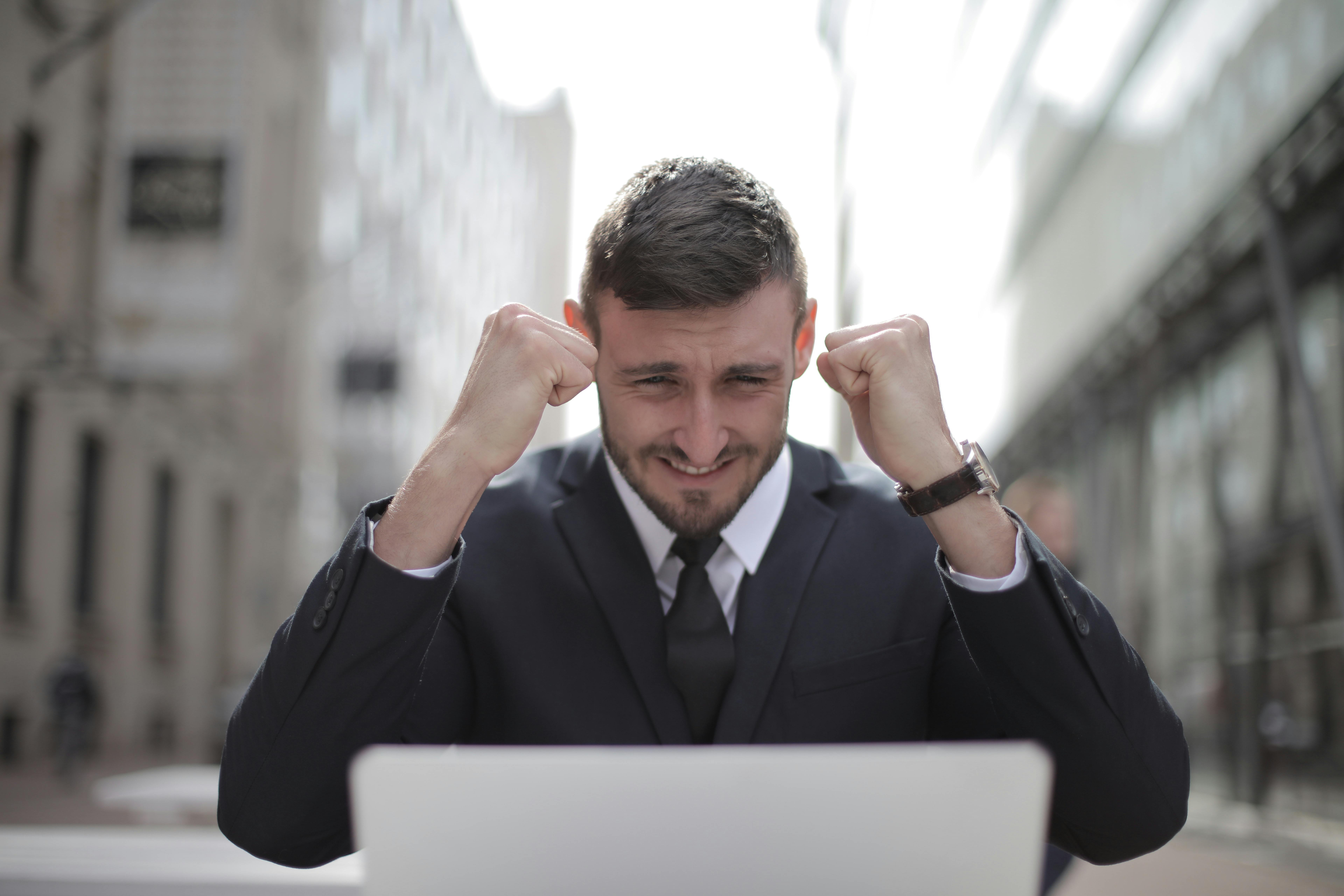 Happy man with a laptop | Source: Pexels