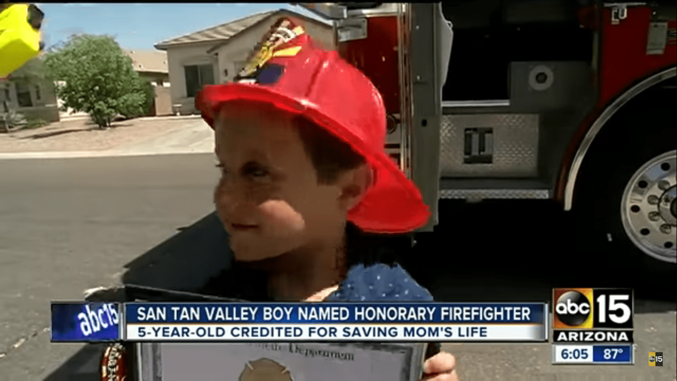 The Rural Metro Fire Department honoring Salvatore with a shirt, a patch, a helmet, and an honorary firefighter certificate | Source: YouTube/ABC15 Arizona