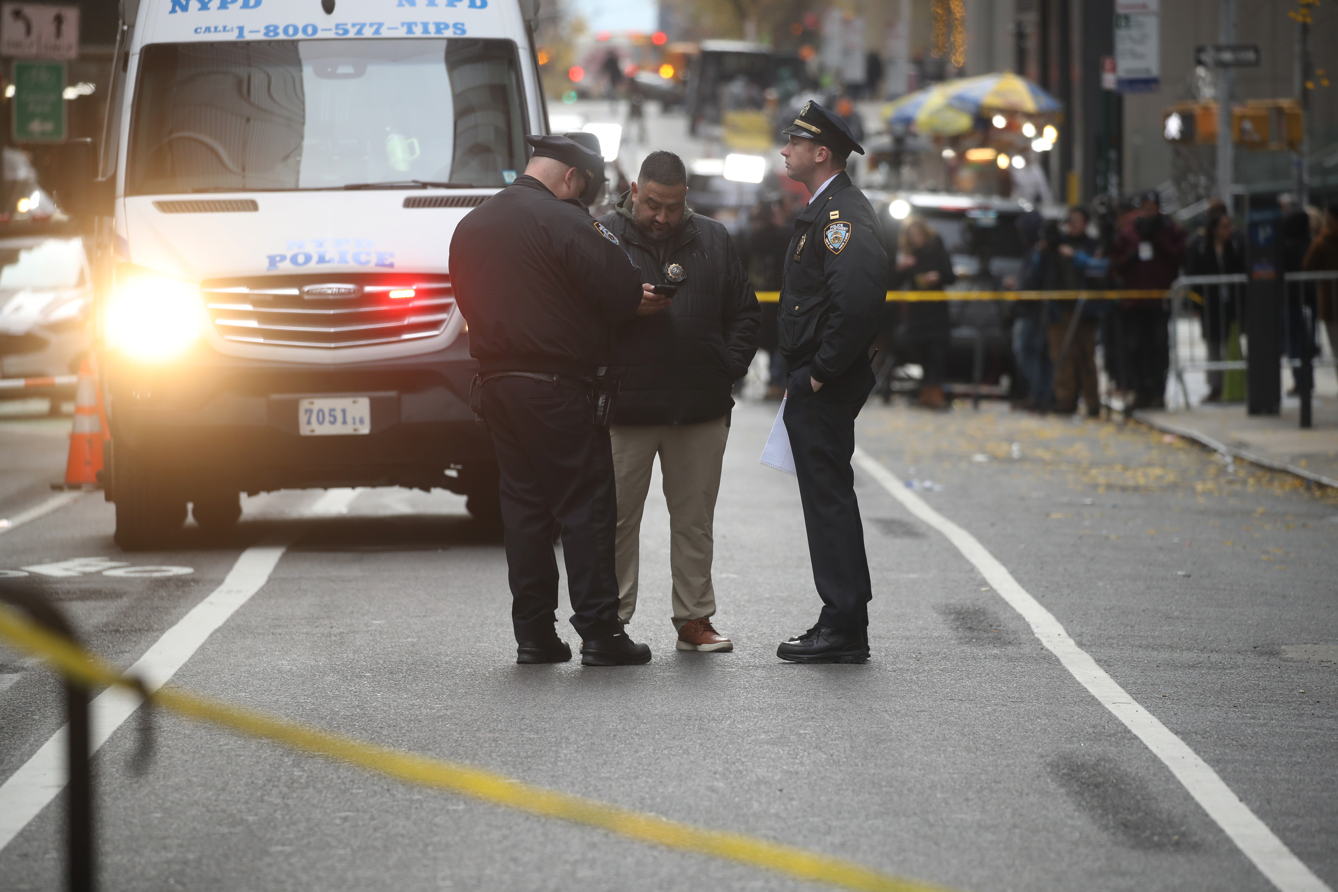 Police gather outside the Hilton Hotel in Midtown Manhattan, where UnitedHealthcare CEO Brian Thompson was fatally shot on December 4, 2024 | Source: Getty Images