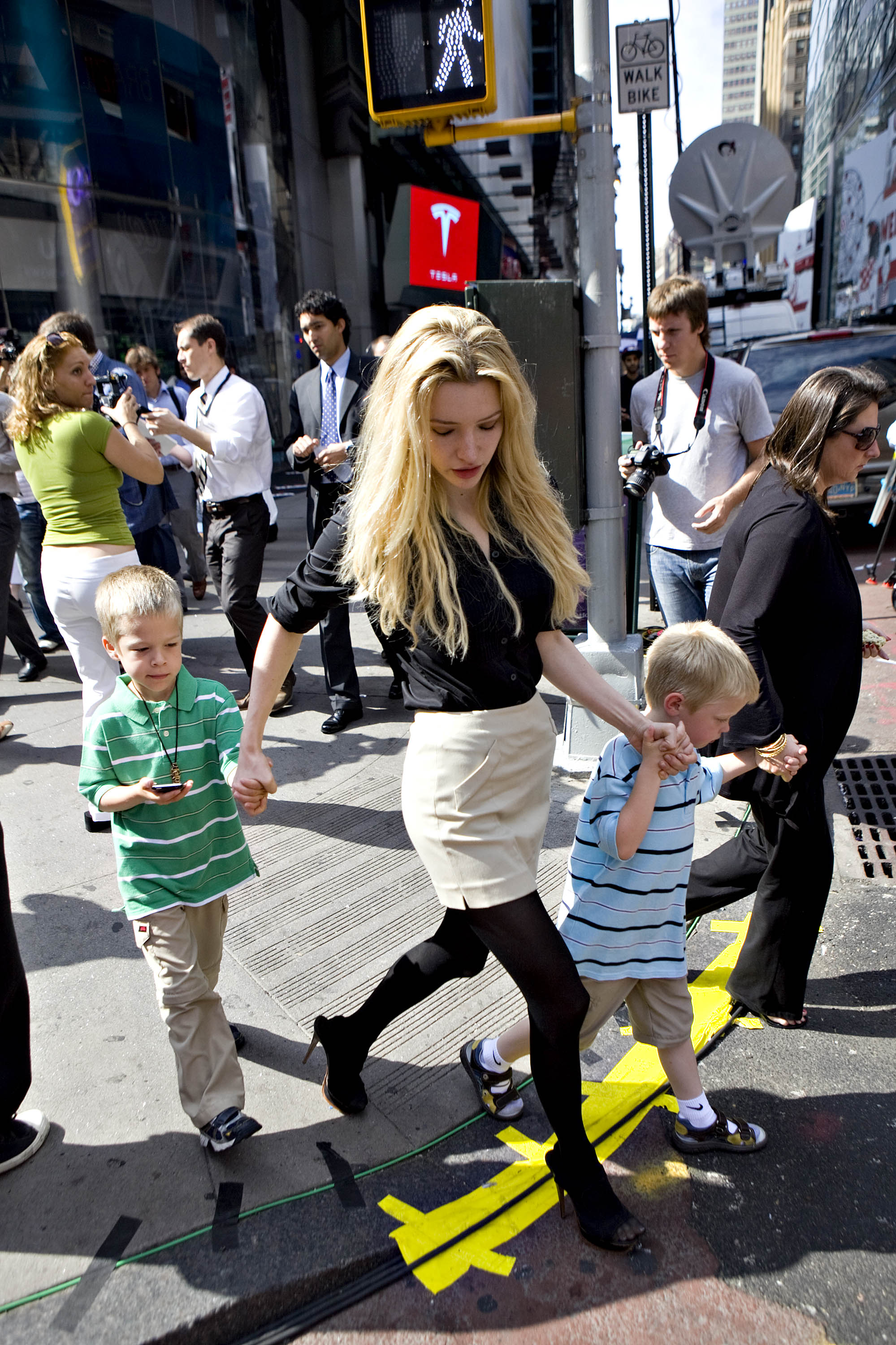 Talulah Riley, fiancee of Elon Musk, chairman and chief executive officer of Tesla Motors, walks with Musk's twin boys Griffin, left, and Xavier, outside the Nasdaq Marketsite in New York, U.S. | Source: Getty Images