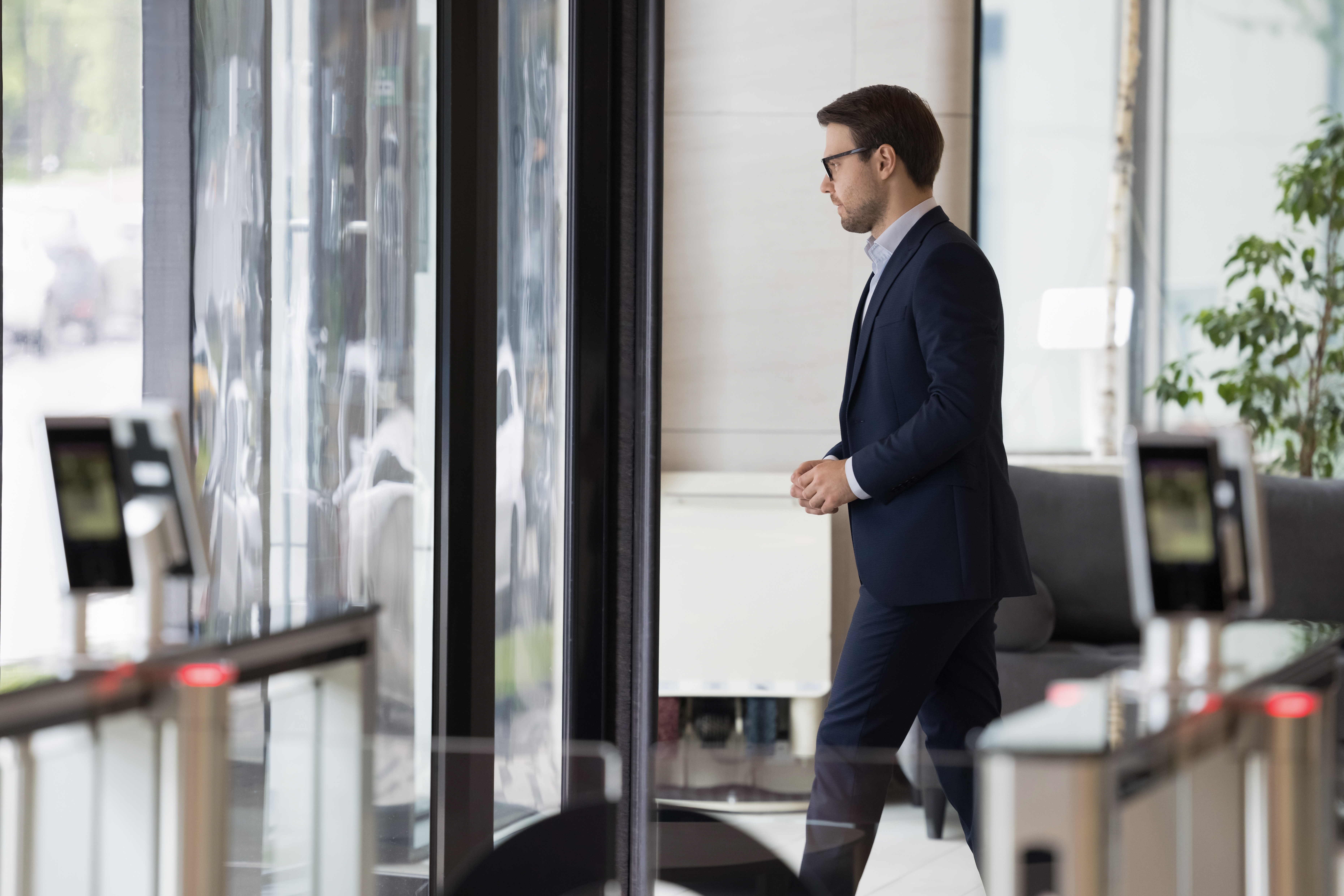 A man leaving an office building | Source: Shutterstock
