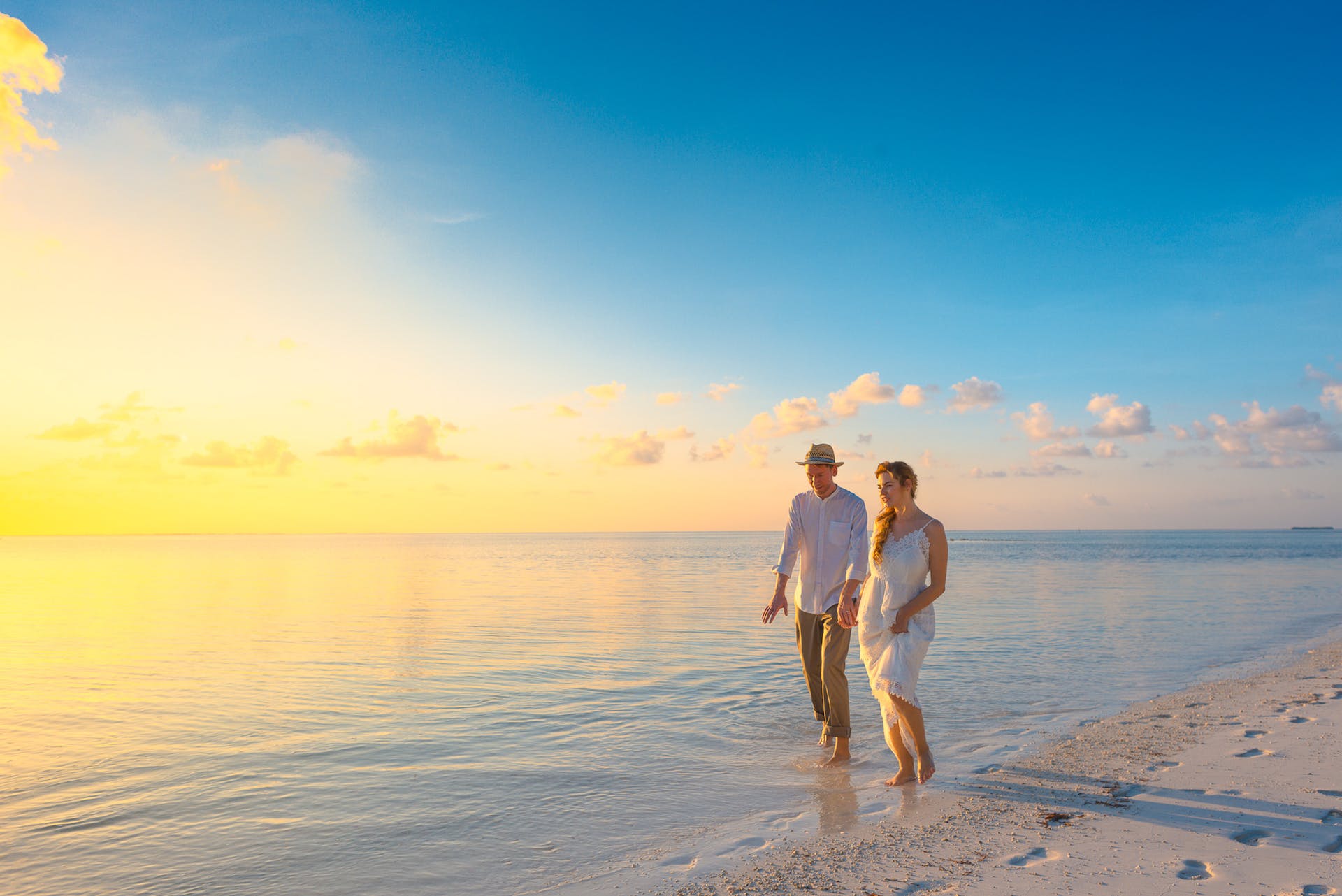 A couple walking on a beach | Source: Pexels