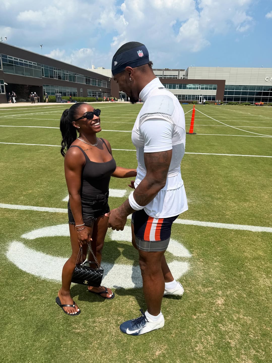 Simone Biles and Jonathan Owens smiling at each other on a football field, from a post dated August 11, 2025 | Source: Instagram/simonebiles