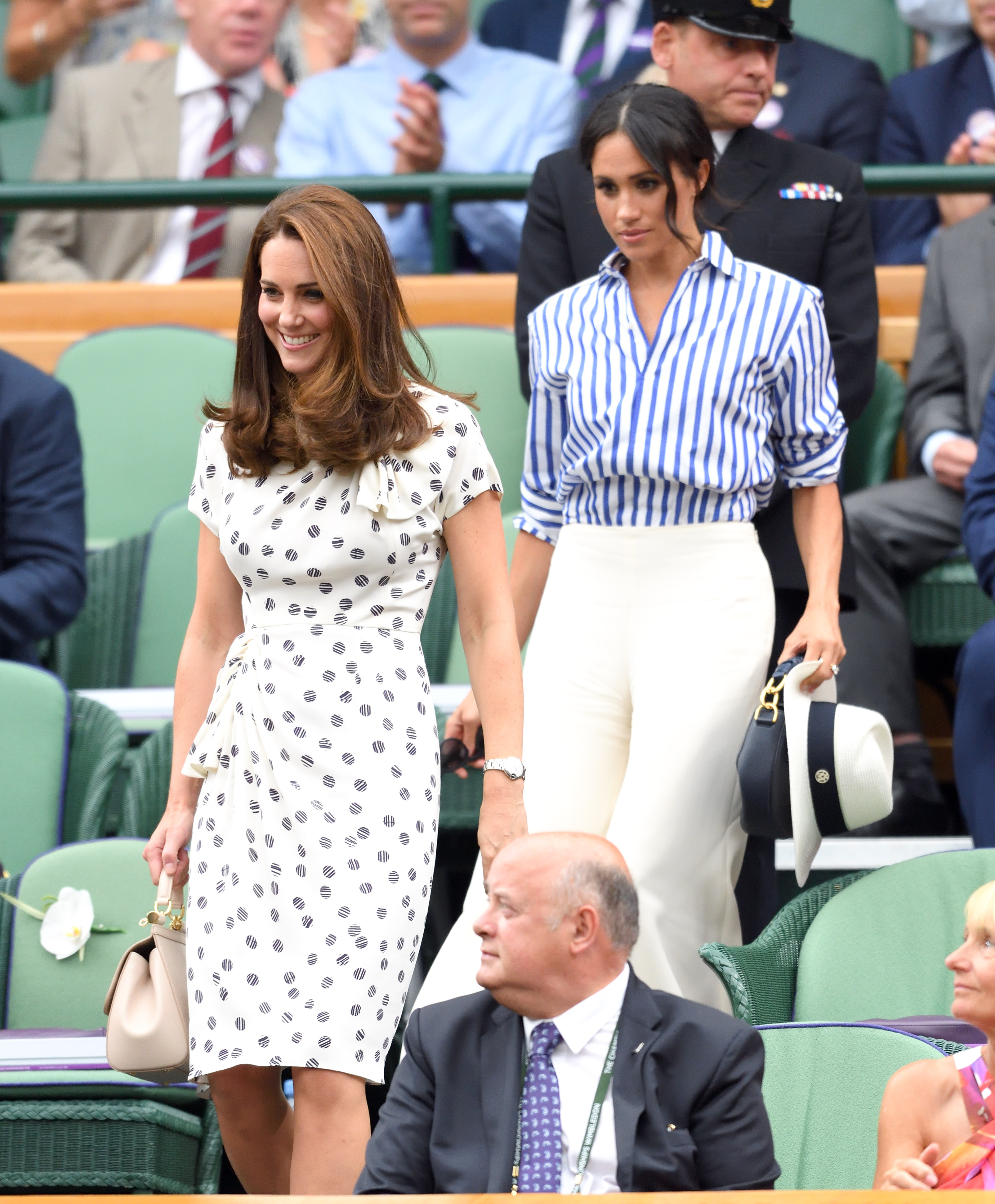 Princess Catherine and Meghan Markle on day twelve of the Wimbledon Tennis Championships at the All England Lawn Tennis and Croquet Club on July 14, 2018 in London, England | Source: Getty Images