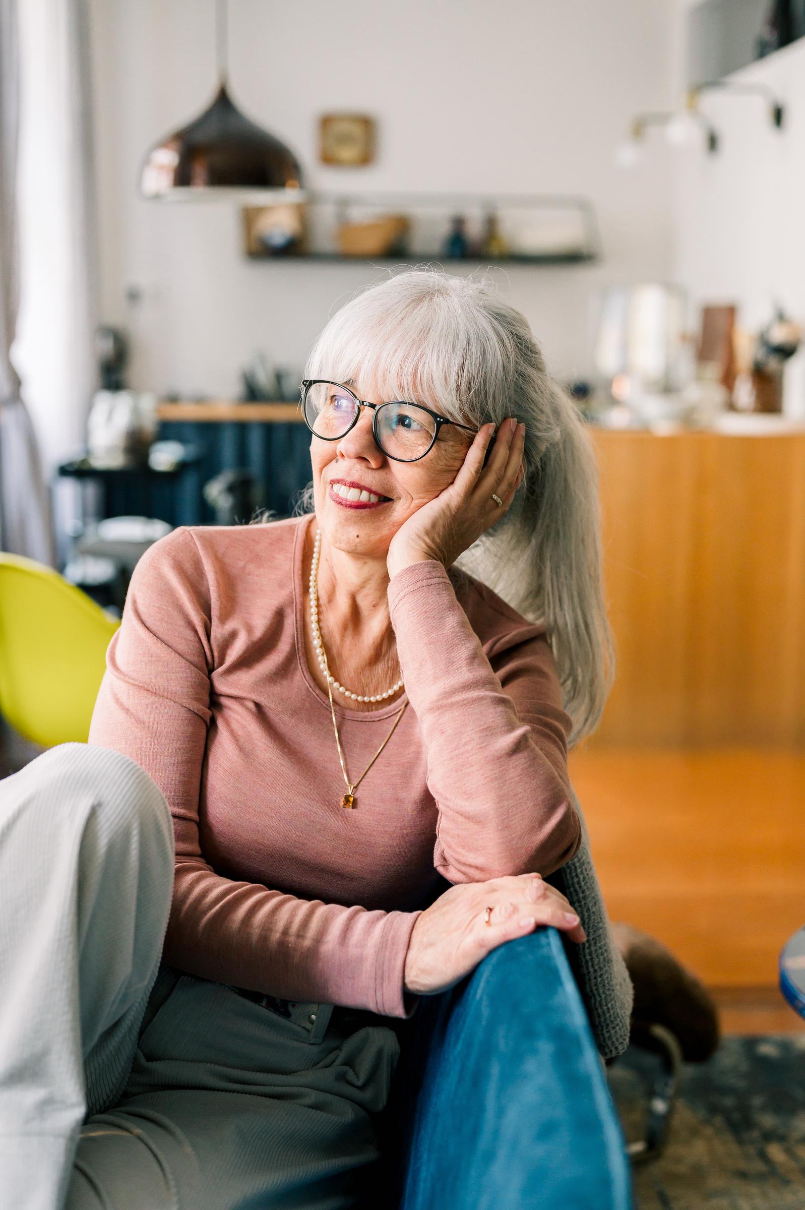 Woman appearing happy at home | Source: Shutterstock