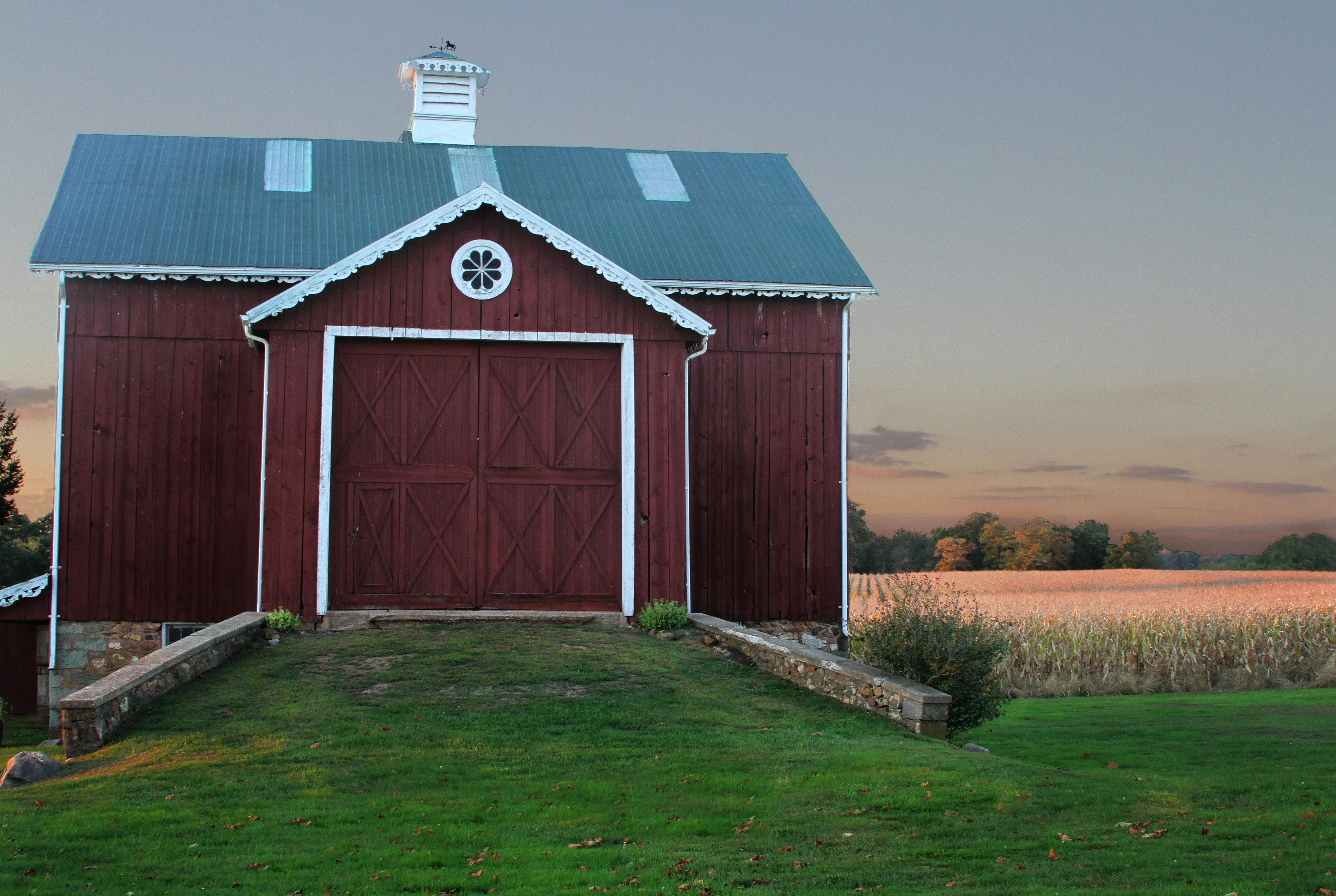 A dark red barn with closed doors | Source: Pexels
