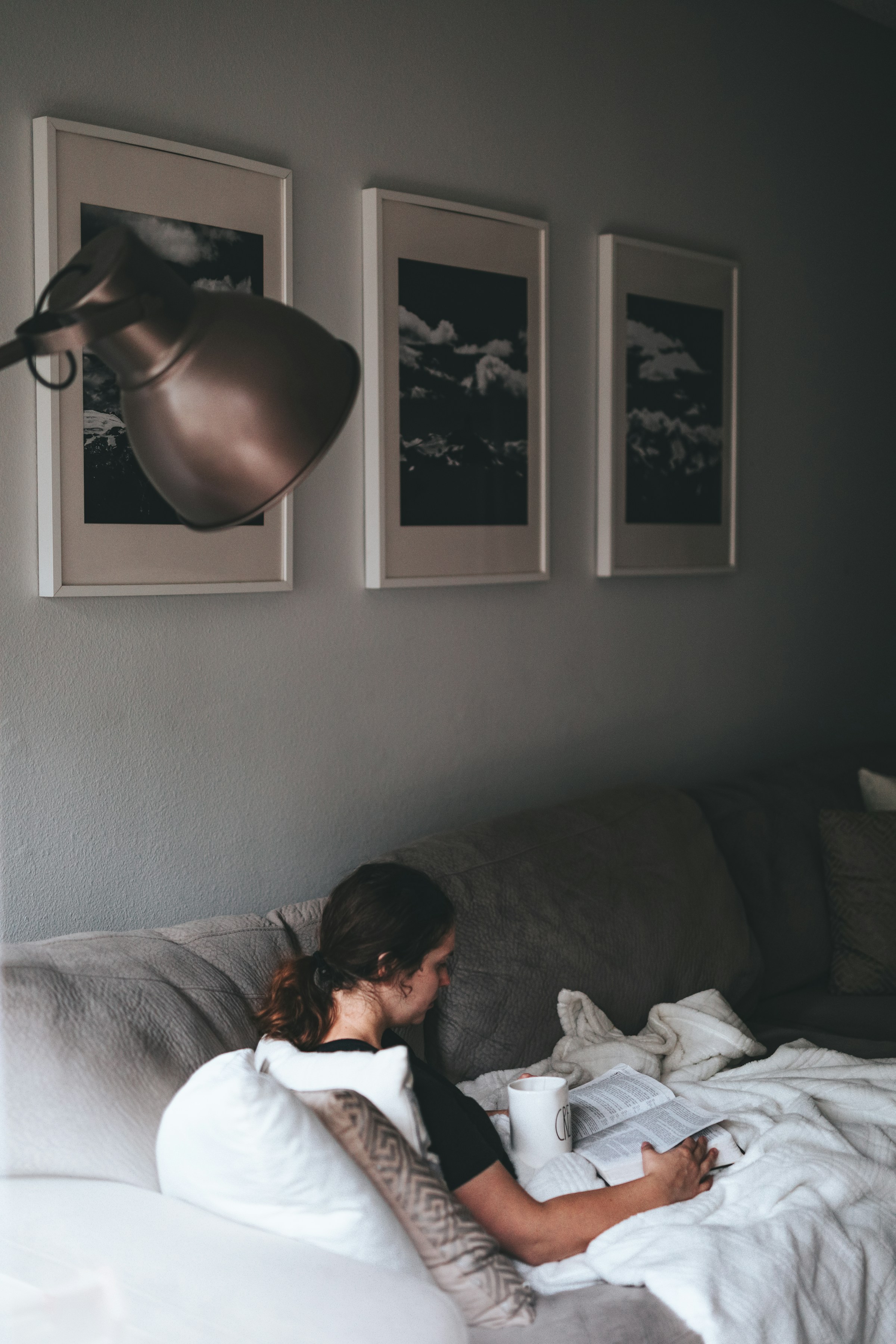 A woman reading on a couch | Source: Unsplash
