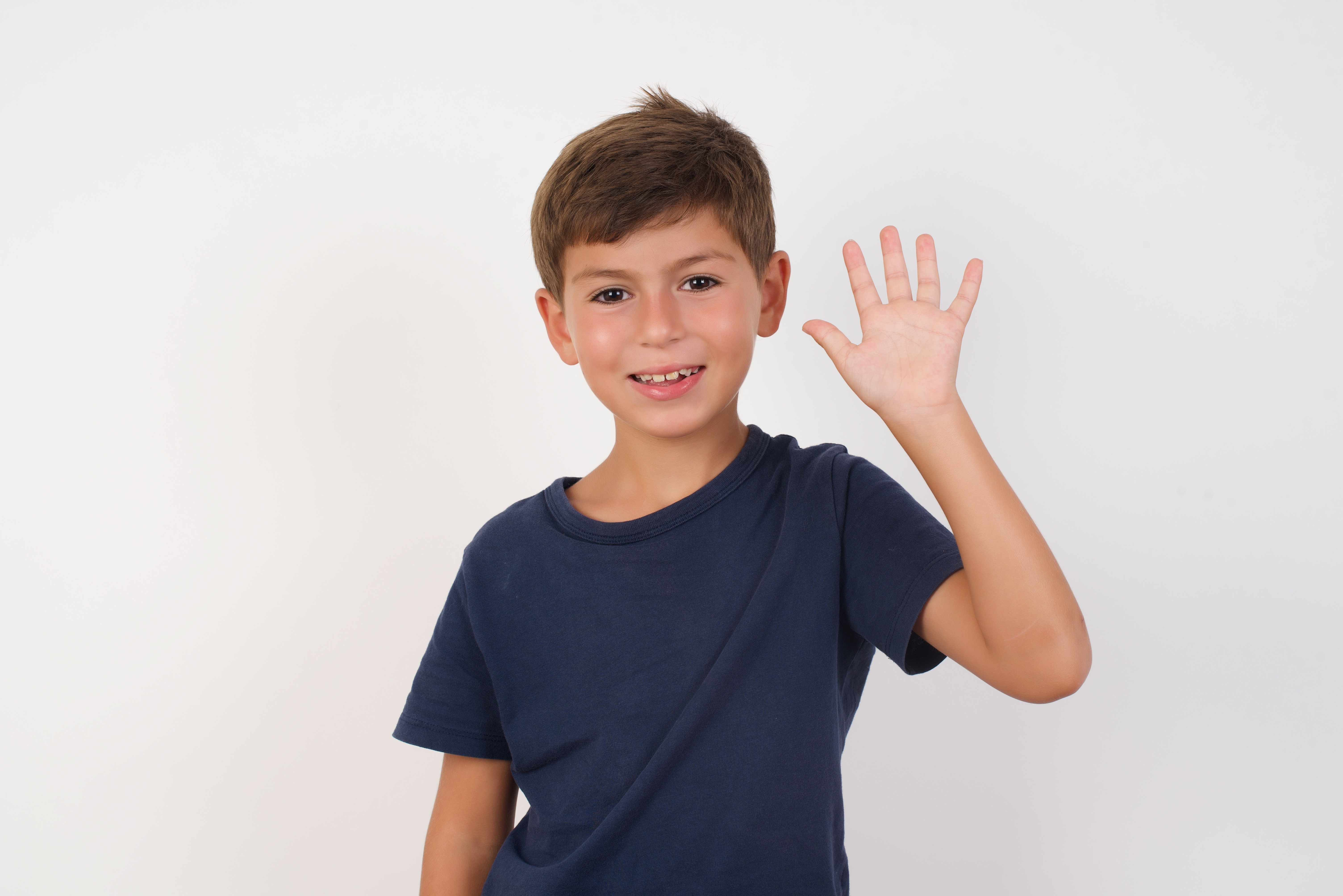 The boy waved hello and shook the woman's hand. | Source: Shutterstock