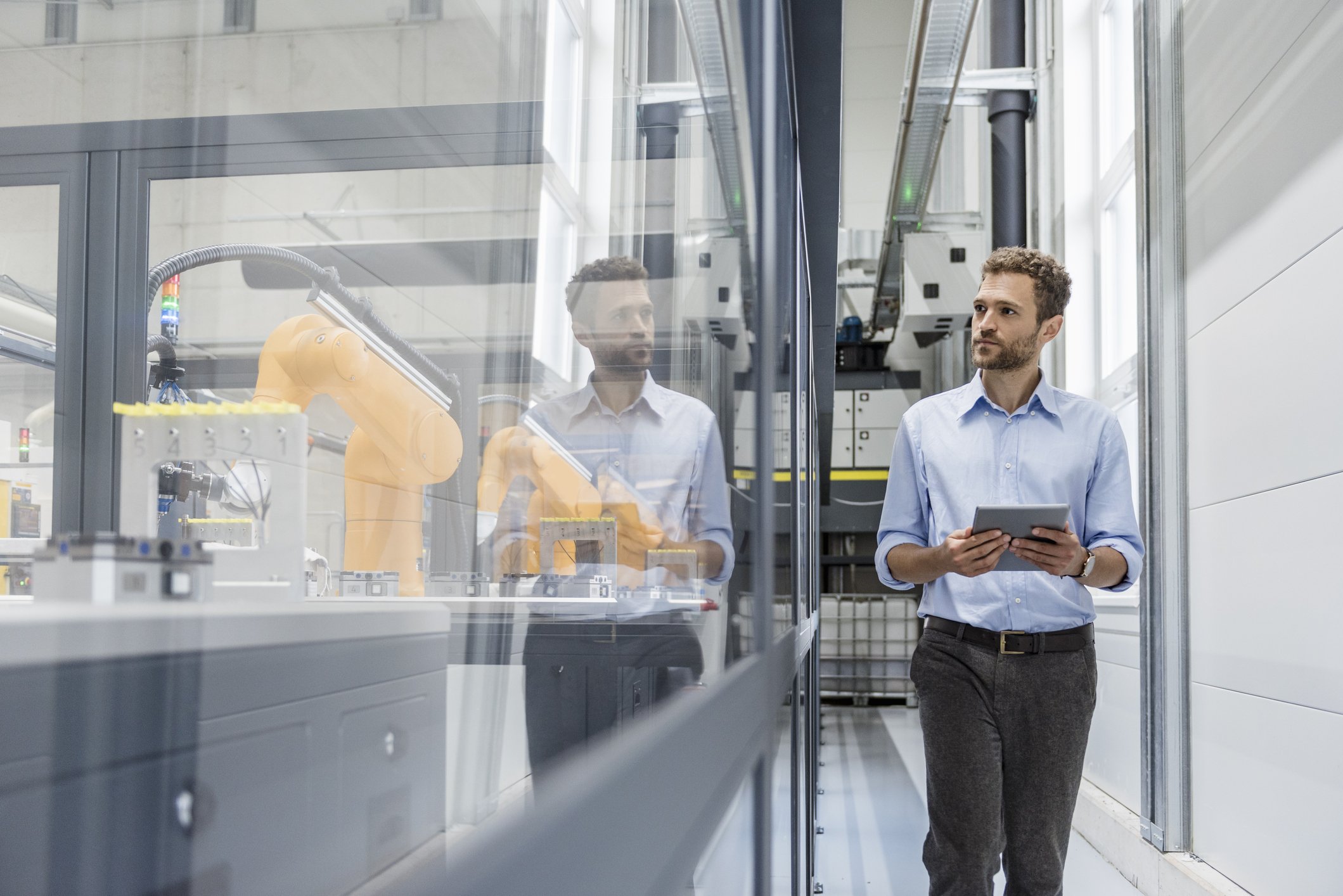 A businessman checking robots with digital tablet in a high tech company. | Photo: Getty Images