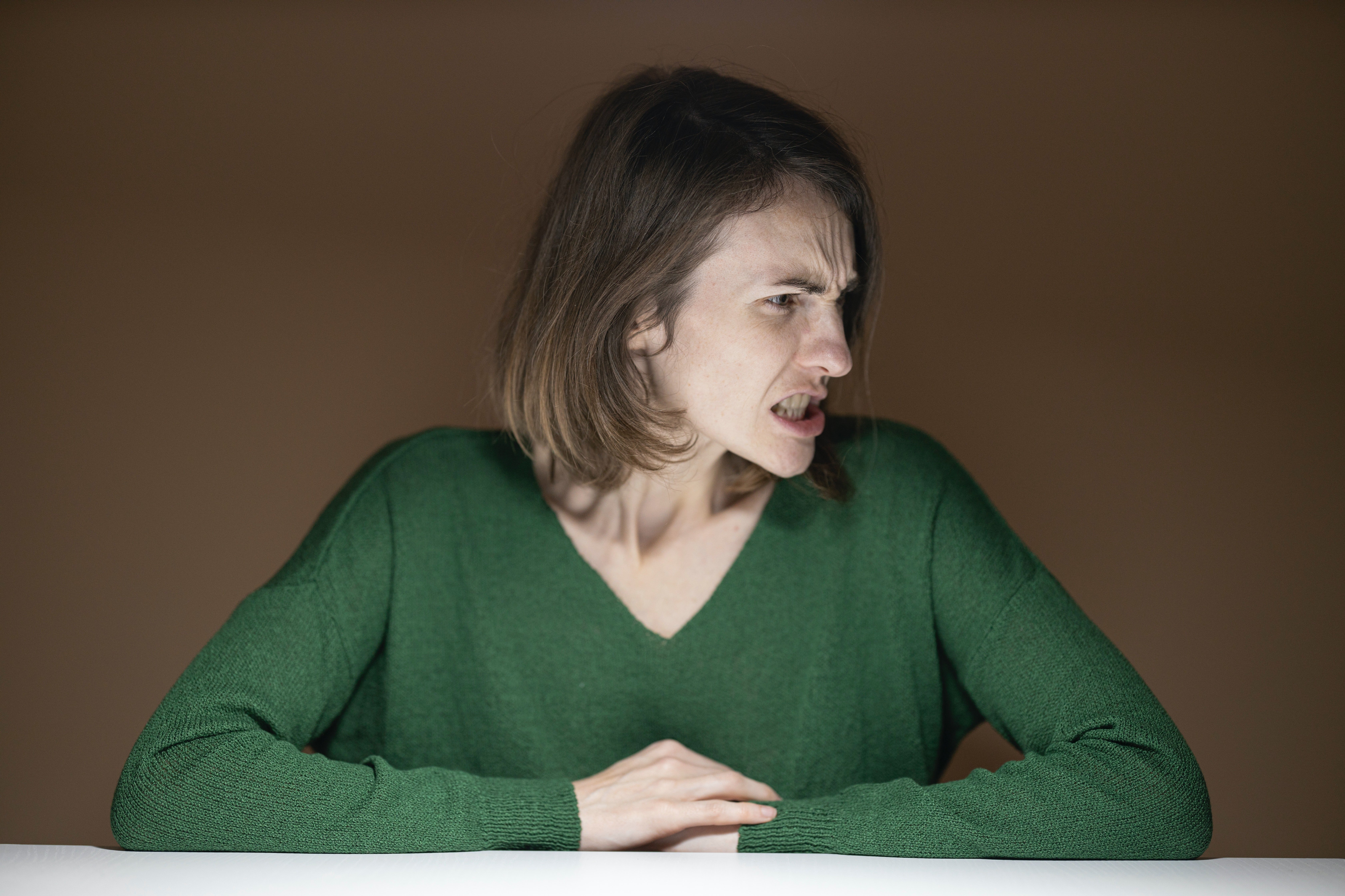 A woman sitting down with an upset look on her face | Source: Pexels