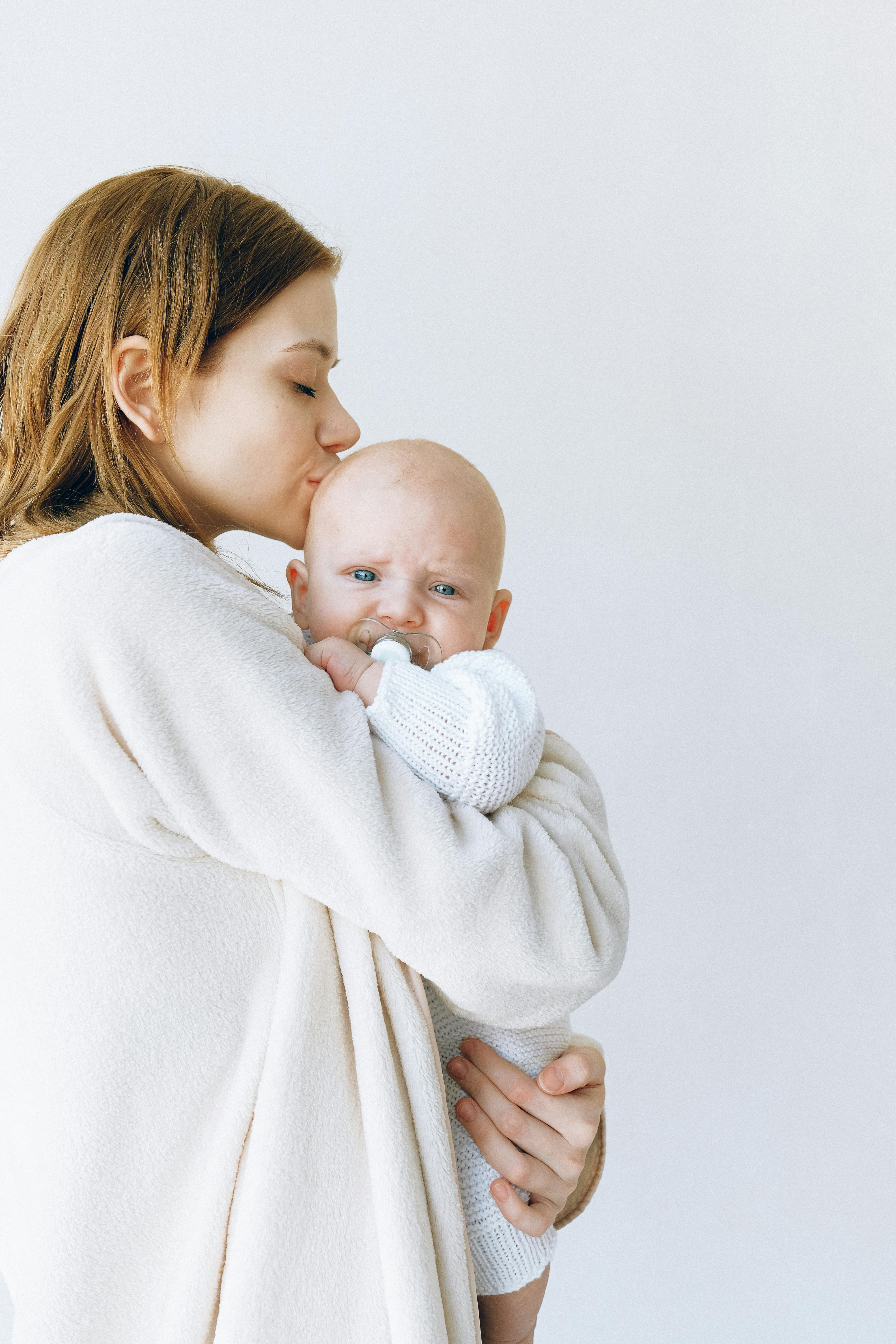 A mother kissing her baby | Source: Pexels