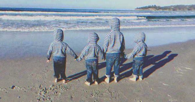 Four kids holding hands while looking at the sea | Source: Shutterstock