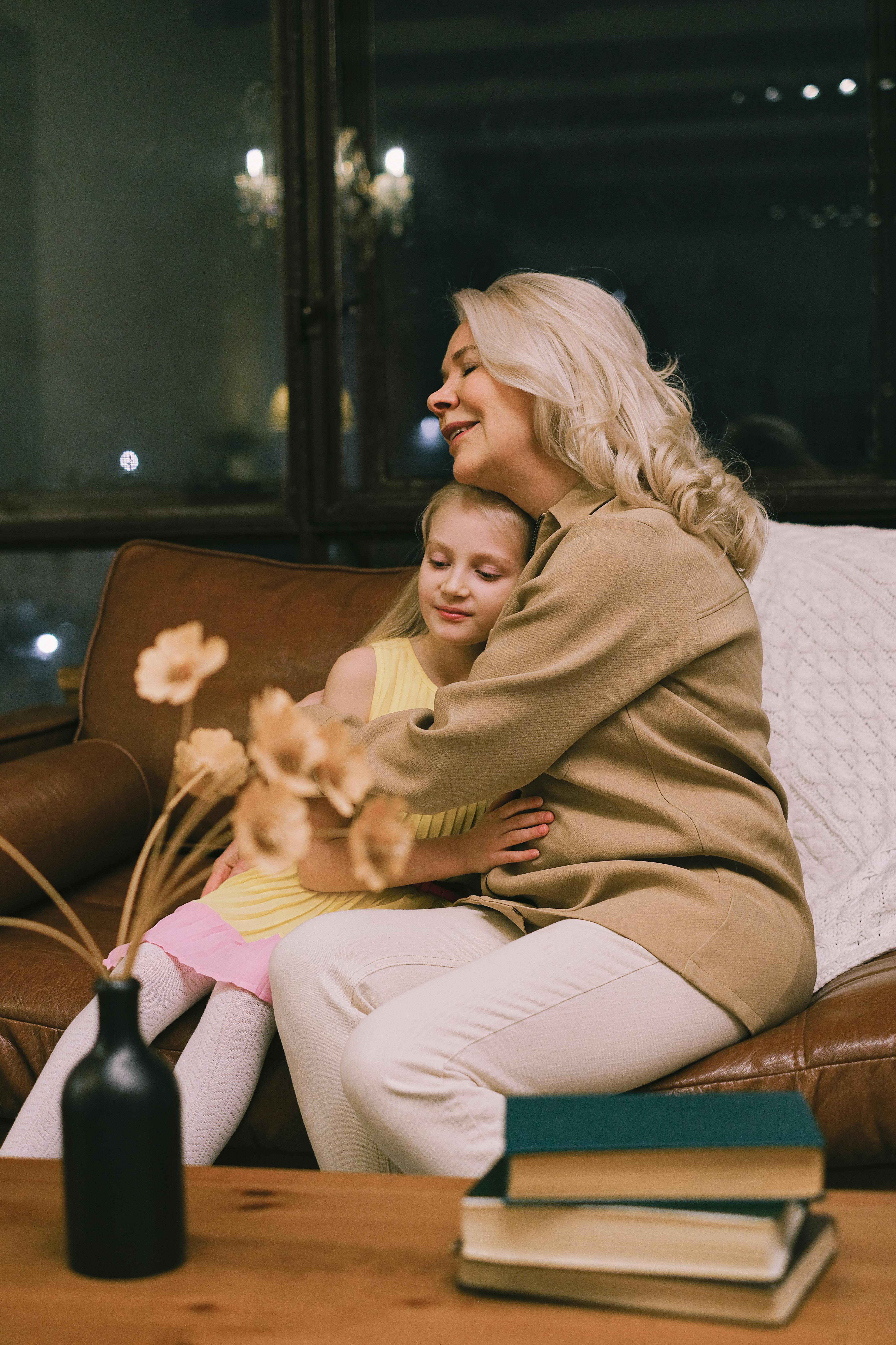 A grandmother hugging her granddaughter | Source: Pexels