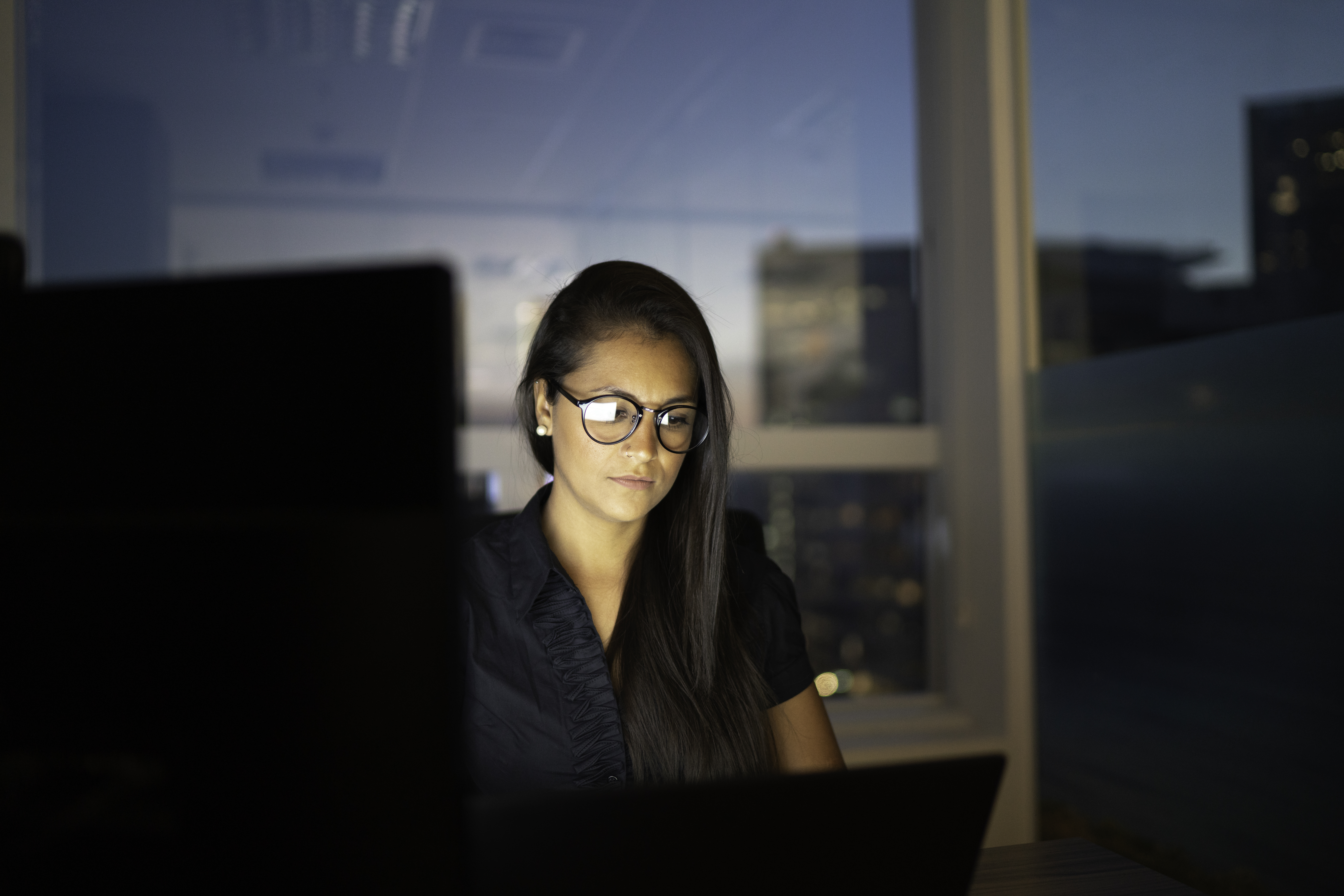 Businesswoman working late in the office | Source: Getty Images