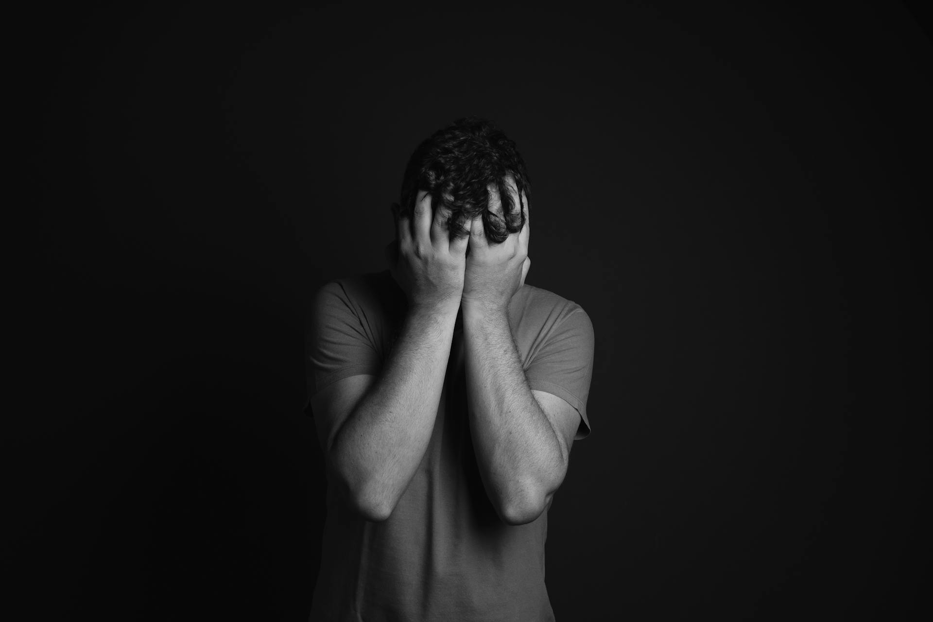 A shocked man covering his face | Source: Pexels