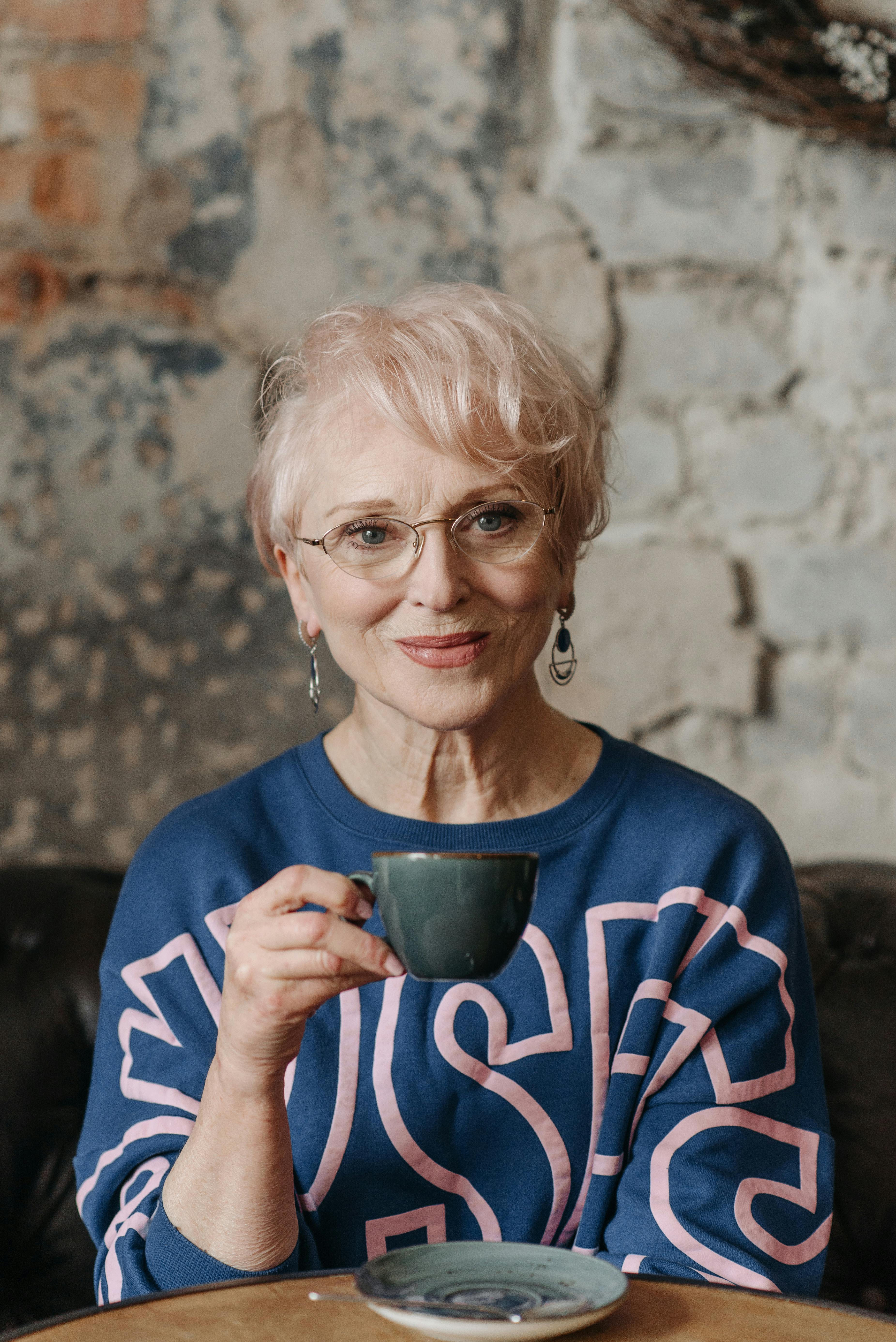 A smiling elderly woman holding a cup | Source: Pexels