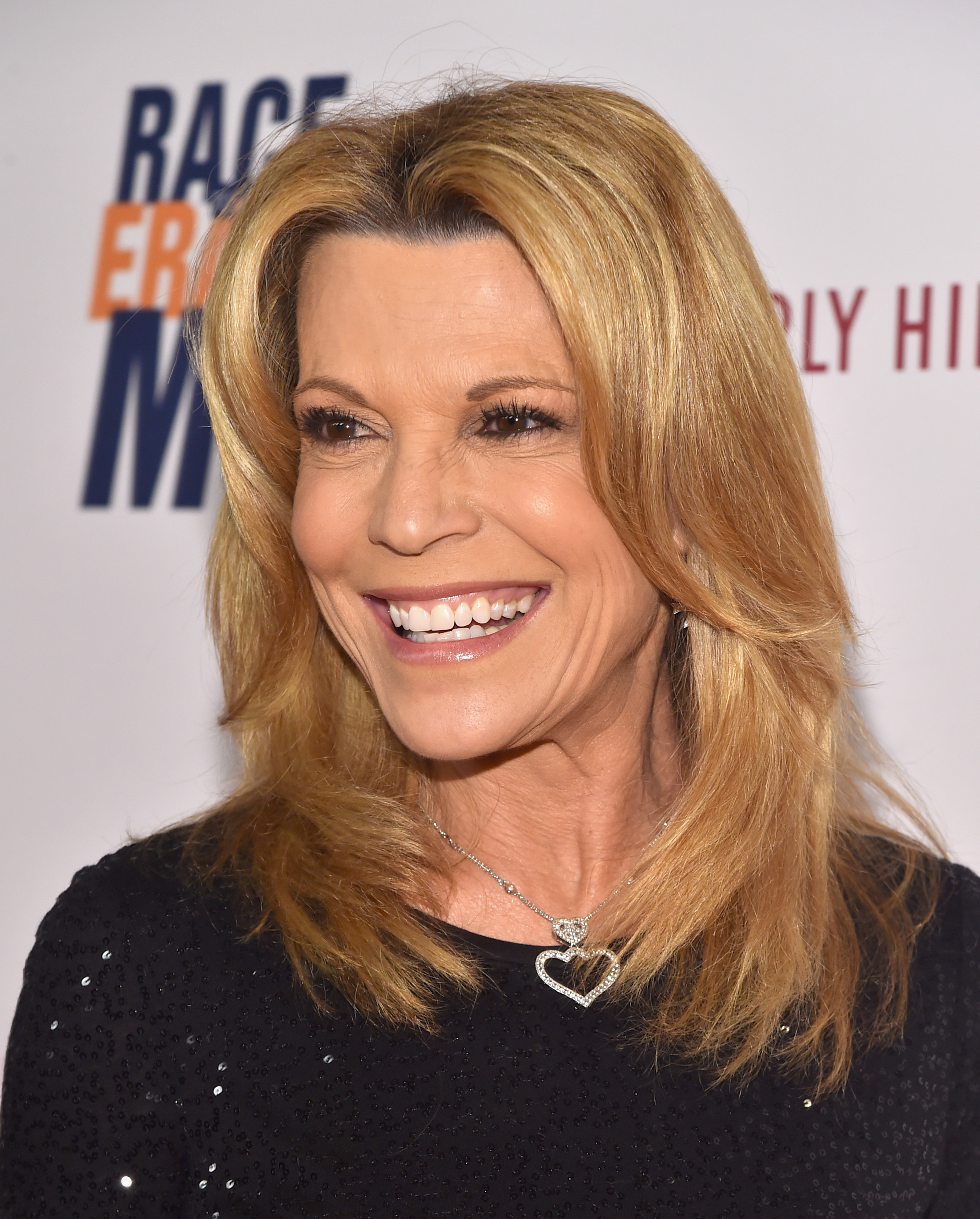 Vanna White laughs in a black sequined top and heart pendant necklace at the 25th Annual Race to Erase MS Gala at The Beverly Hilton Hotel.