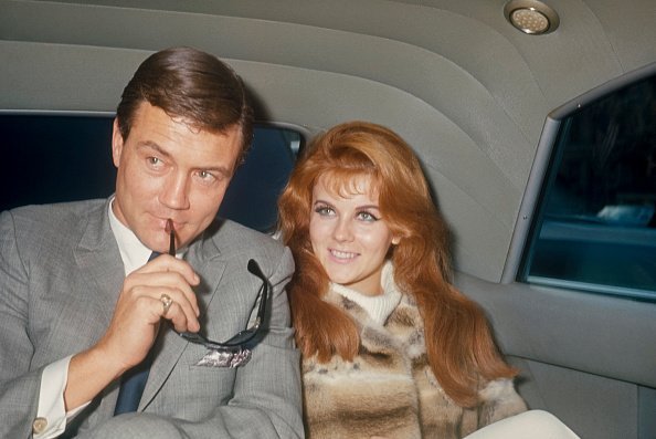Roger Smith with sun glasses and Ann-Margret in the back of a limo; circa 1970. | Source: Getty Images