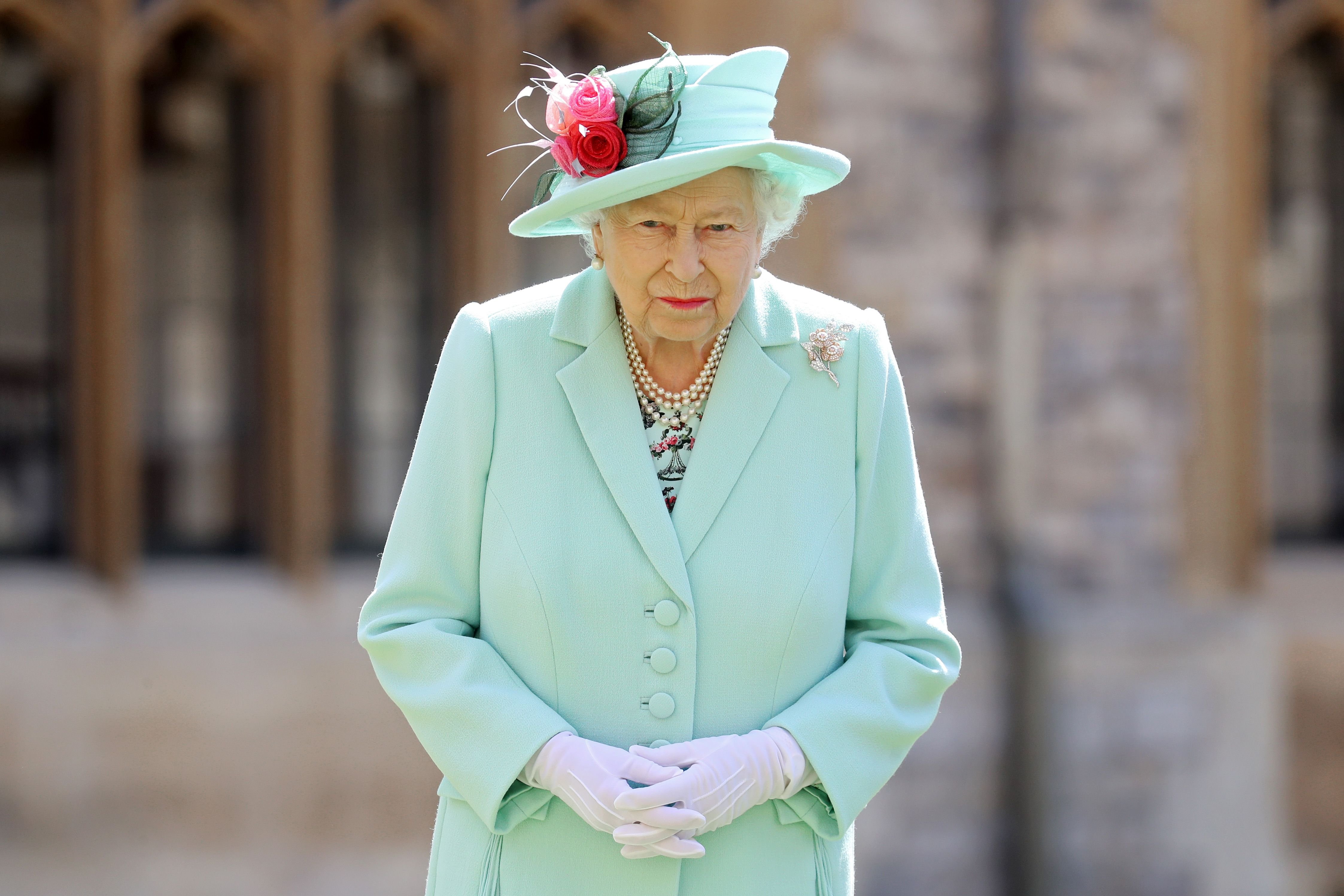 Queen Elizabeth II after awarding Captain Sir Thomas Moore with the insignia of Knight Bachelor at Windsor Castle on July 17, 2020 | Getty Images