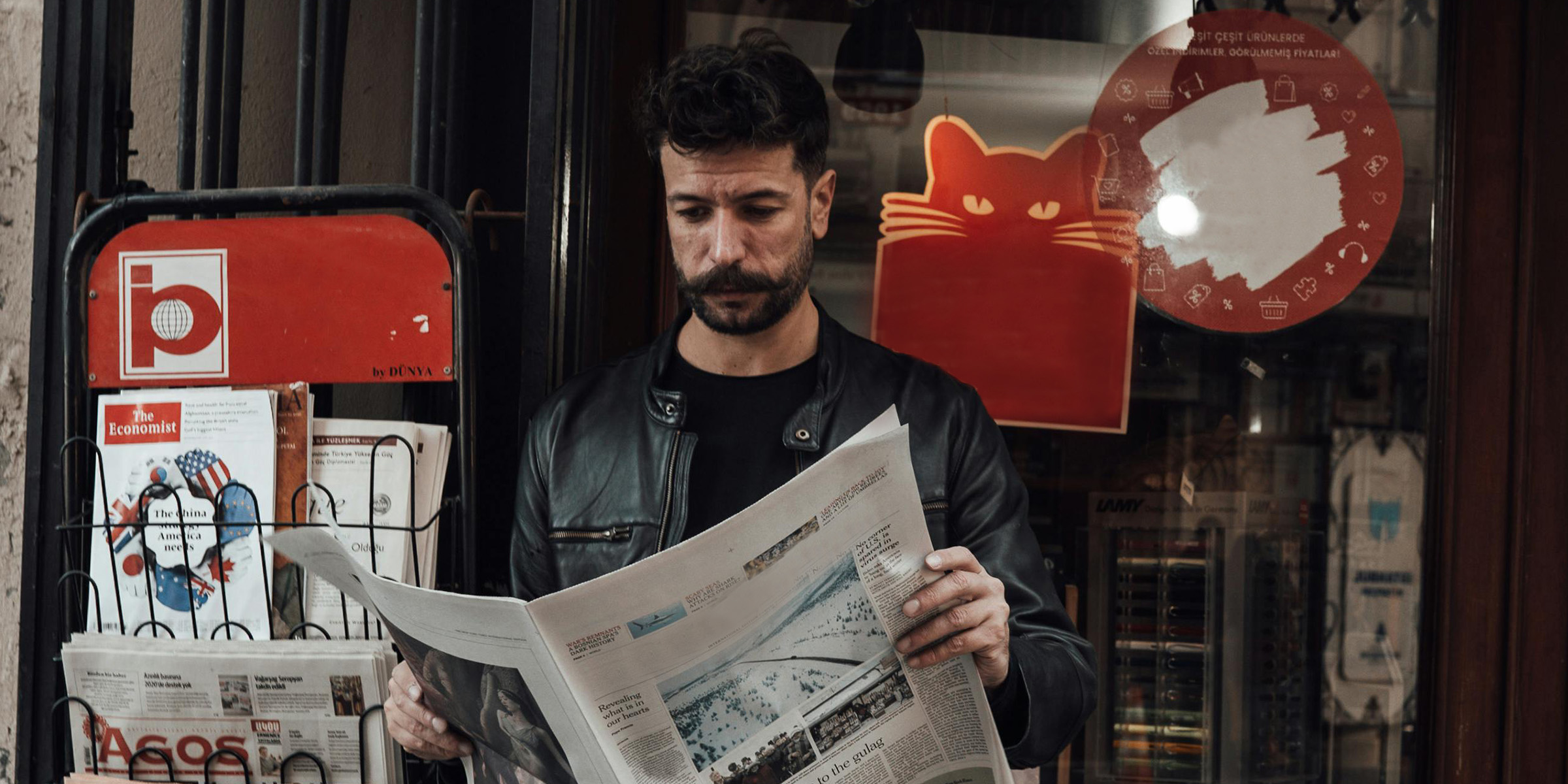 A tourist reading a newspaper by the book-store | Source: Pexels