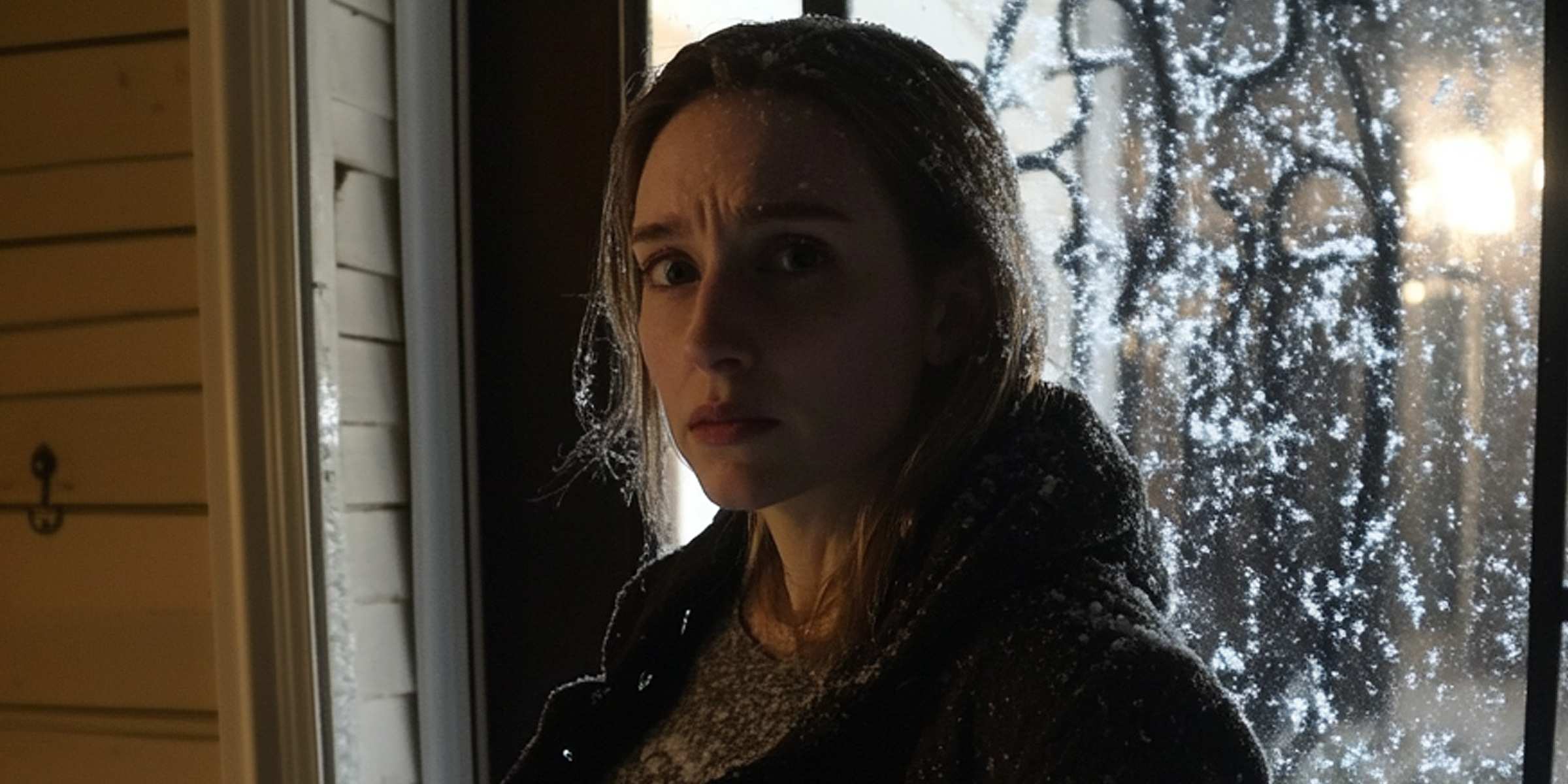 A scared woman on a snowy porch | Source: Amomama