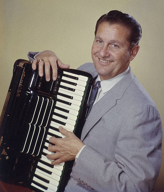 Lawrence Welk, US musician and band leader, smiling while posing with an accordian, circa 1955 | Source:Getty Images