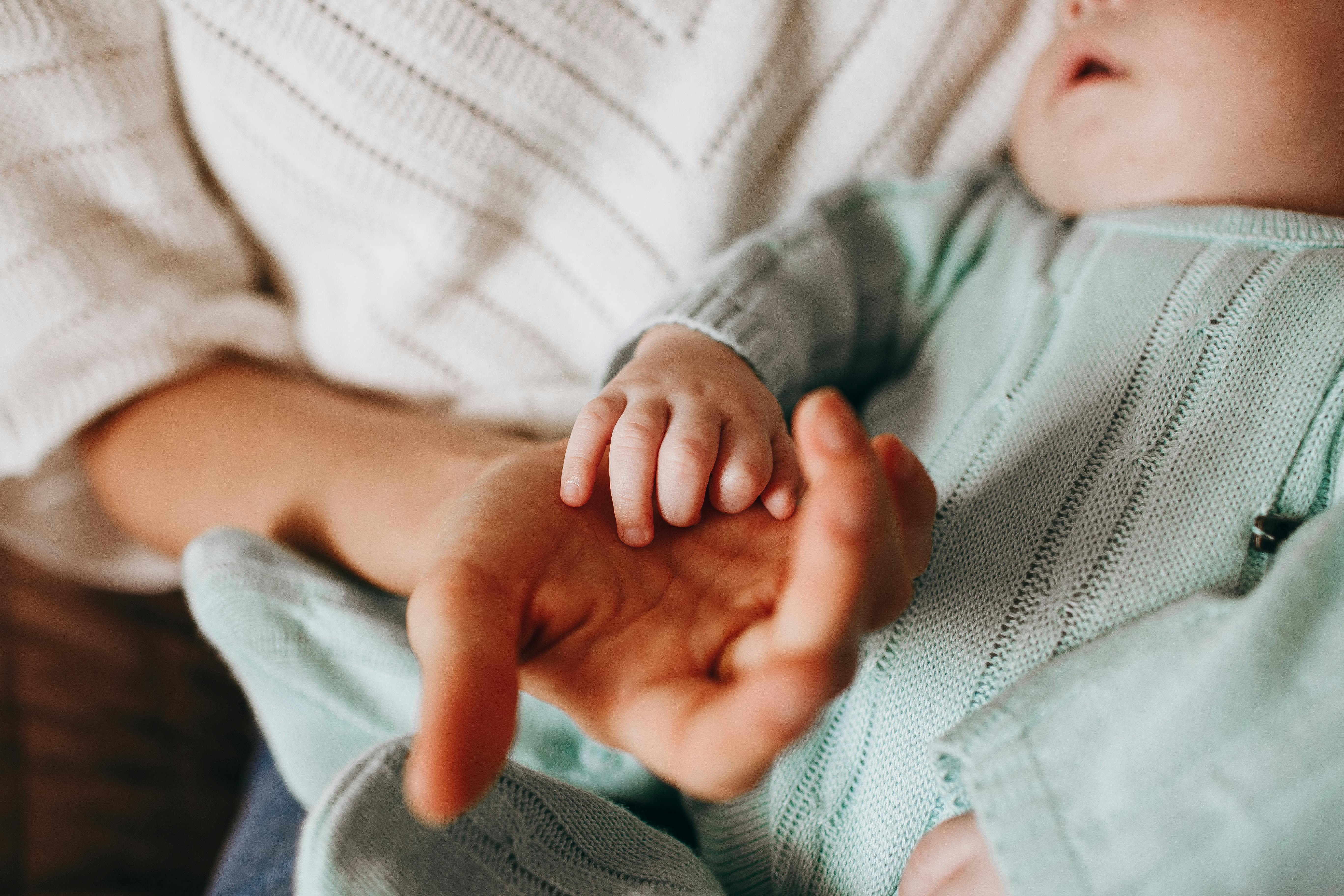 A woman cuddling a baby | Source: Pexels