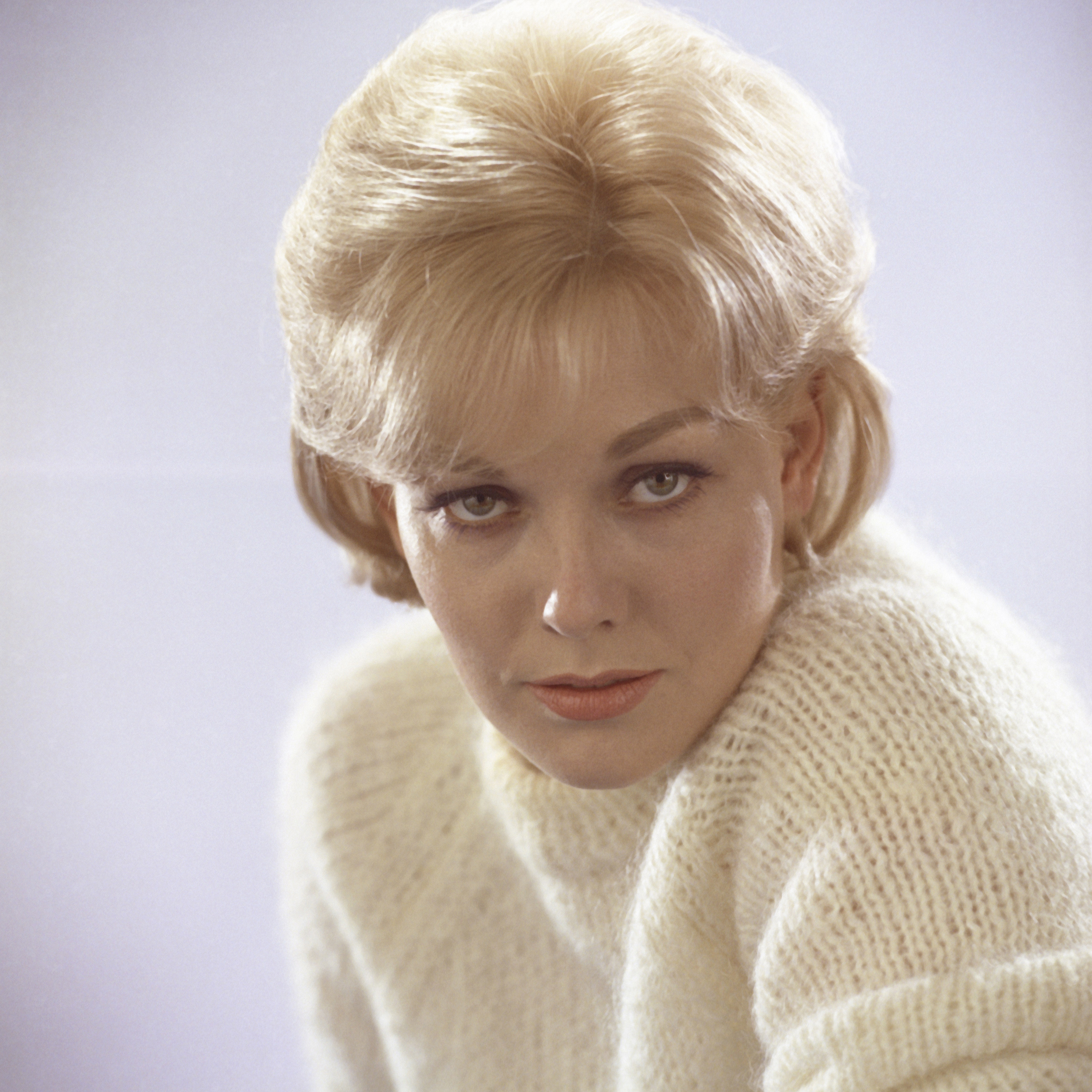 Kim Novak studio publicity portrait posing in white sweater circa 1960. | Source: Getty Images