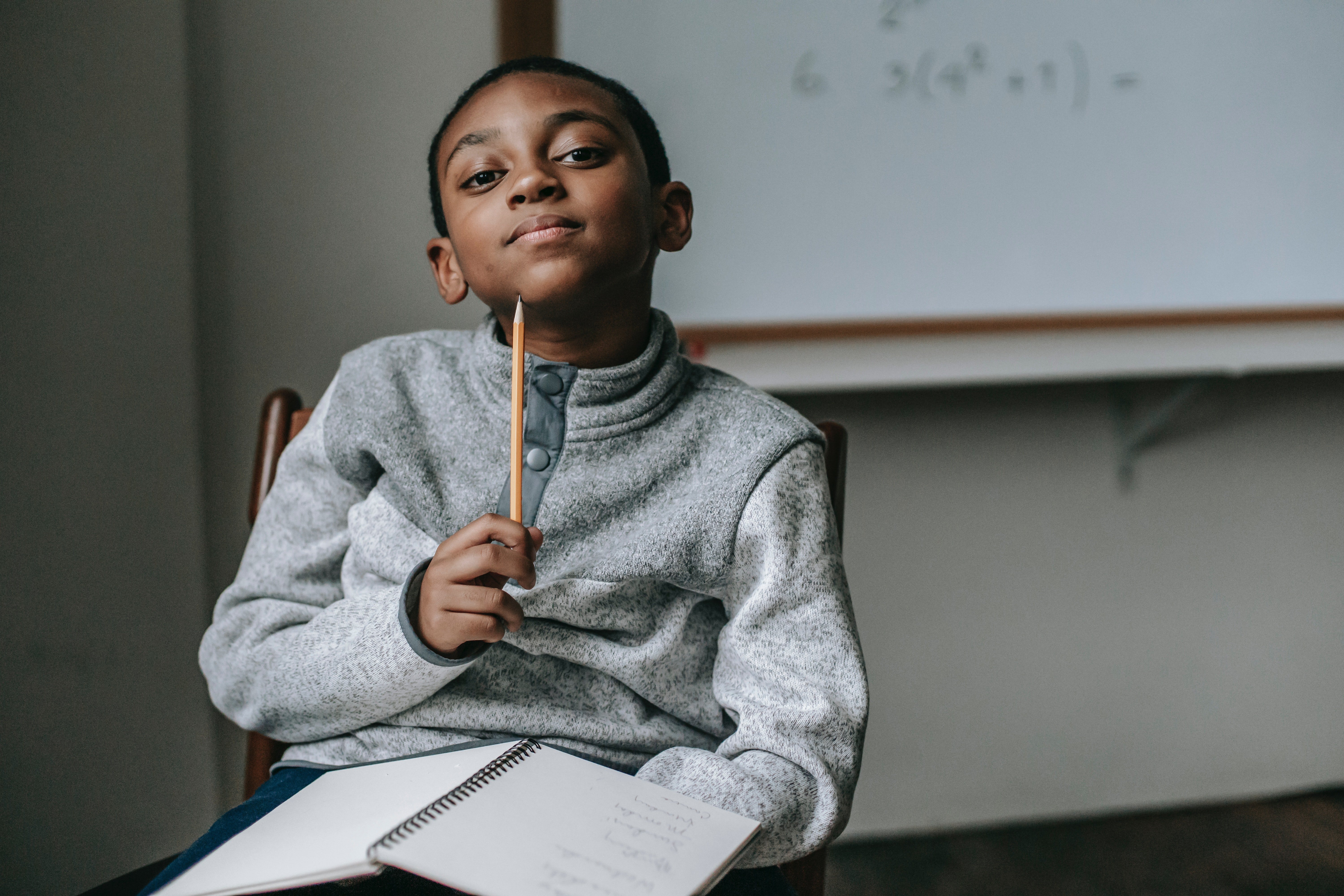 A thoughtful school kid sitting on a chair. | Photo: Pexels/Katerina Holmes