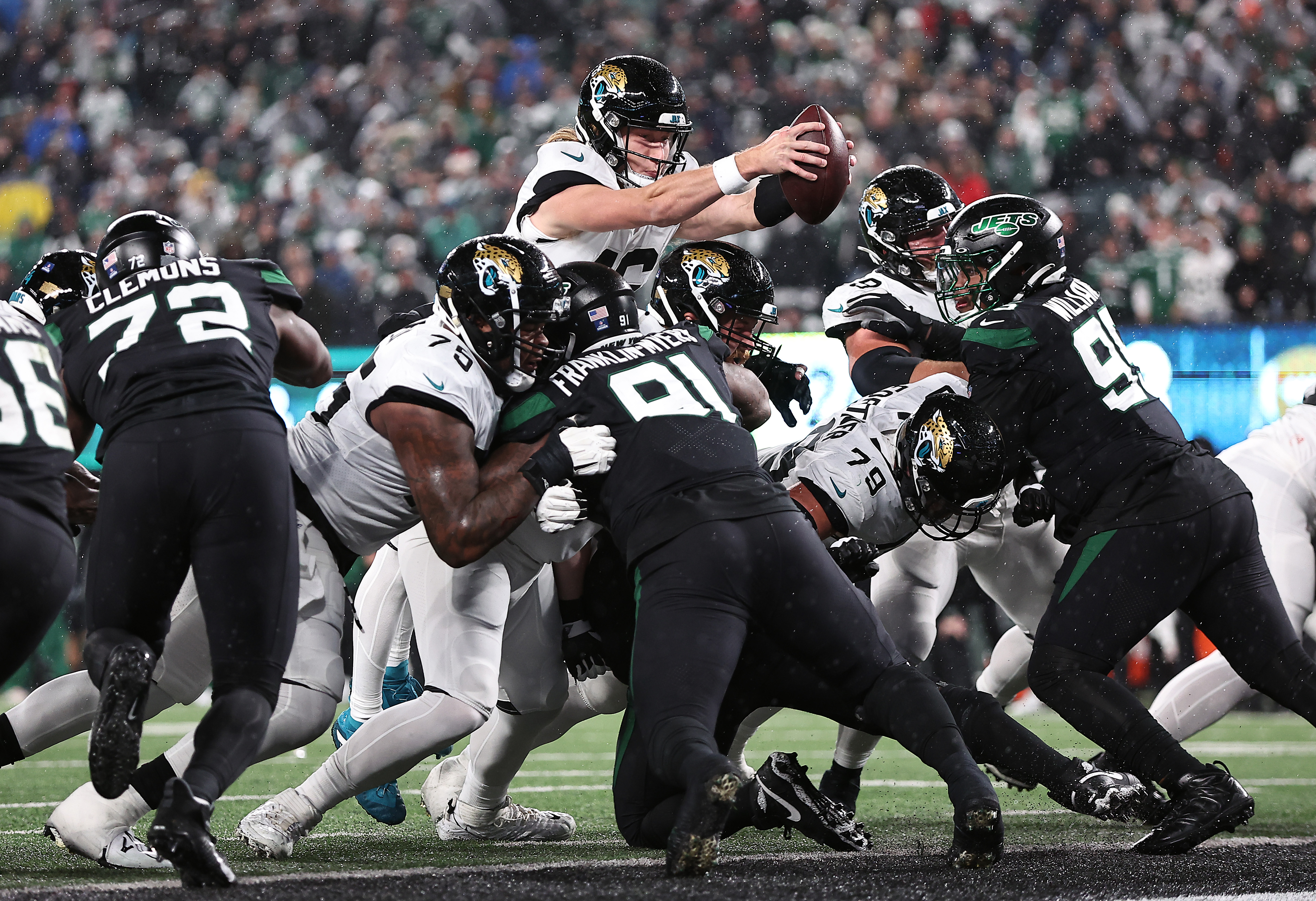 Jacksonville Jaguars scores a touchdown by diving over the goal line against the New York Jets at MetLife Stadium in New Jersey on December 22, 2022 | Source: Getty Images