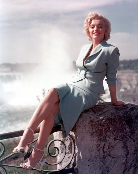  Actress Marilyn Monroe poses for a portrait in front of Niagara Falls dressed as Rose Loomis from the film "Niagara" | Photo: Getty Images