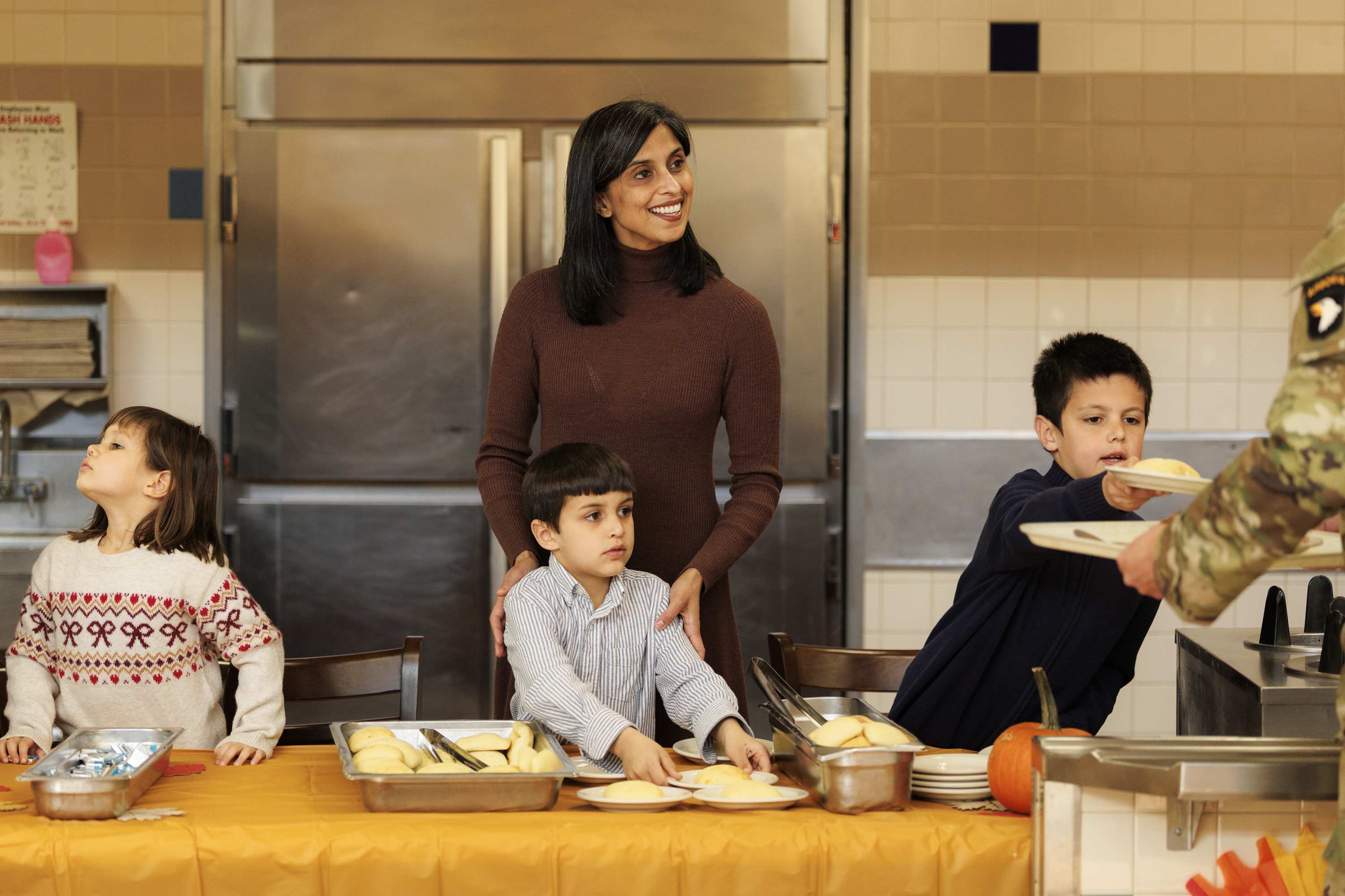 Usha Vance serves food with her children during a Thanksgiving visit to Fort Campbell, Tennessee on November 26, 2025 | Source: Getty Images