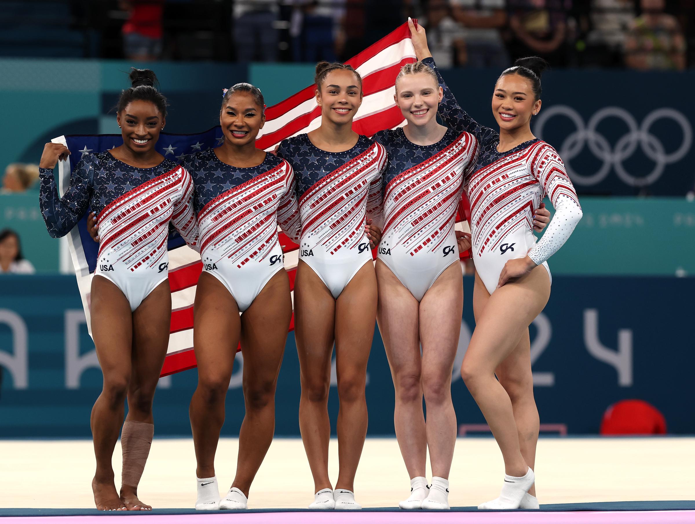 (L-R) Simone Biles, Jordan Chiles, Hezly Rivera, Jade Carey and Sunisa Lee celebrate during the Artistic Gymnastics Women's Team Final on July 30, 2024, in Paris, France. | Source: Getty Images