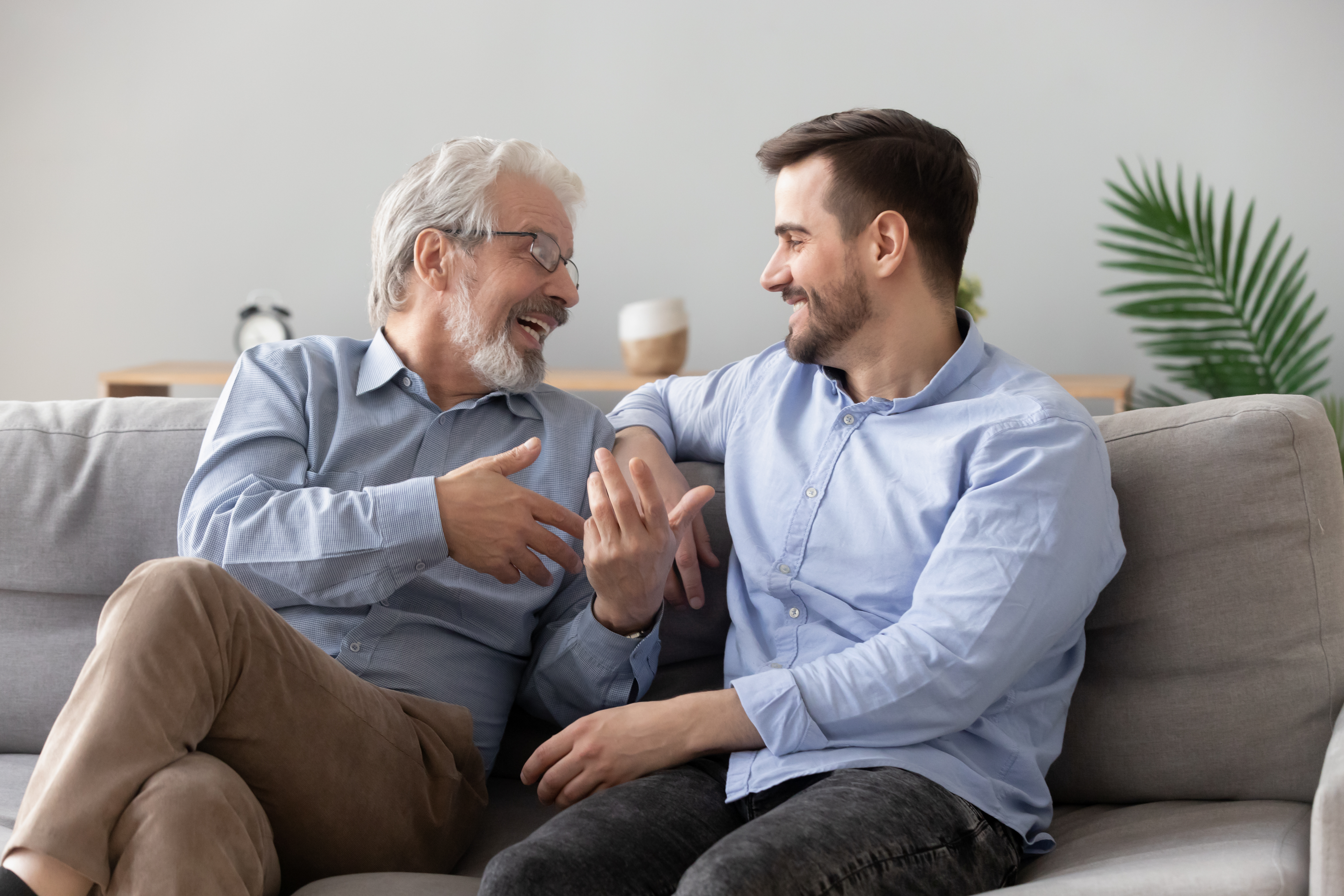 Senior dad chatting with his adult son | Source: Shutterstock