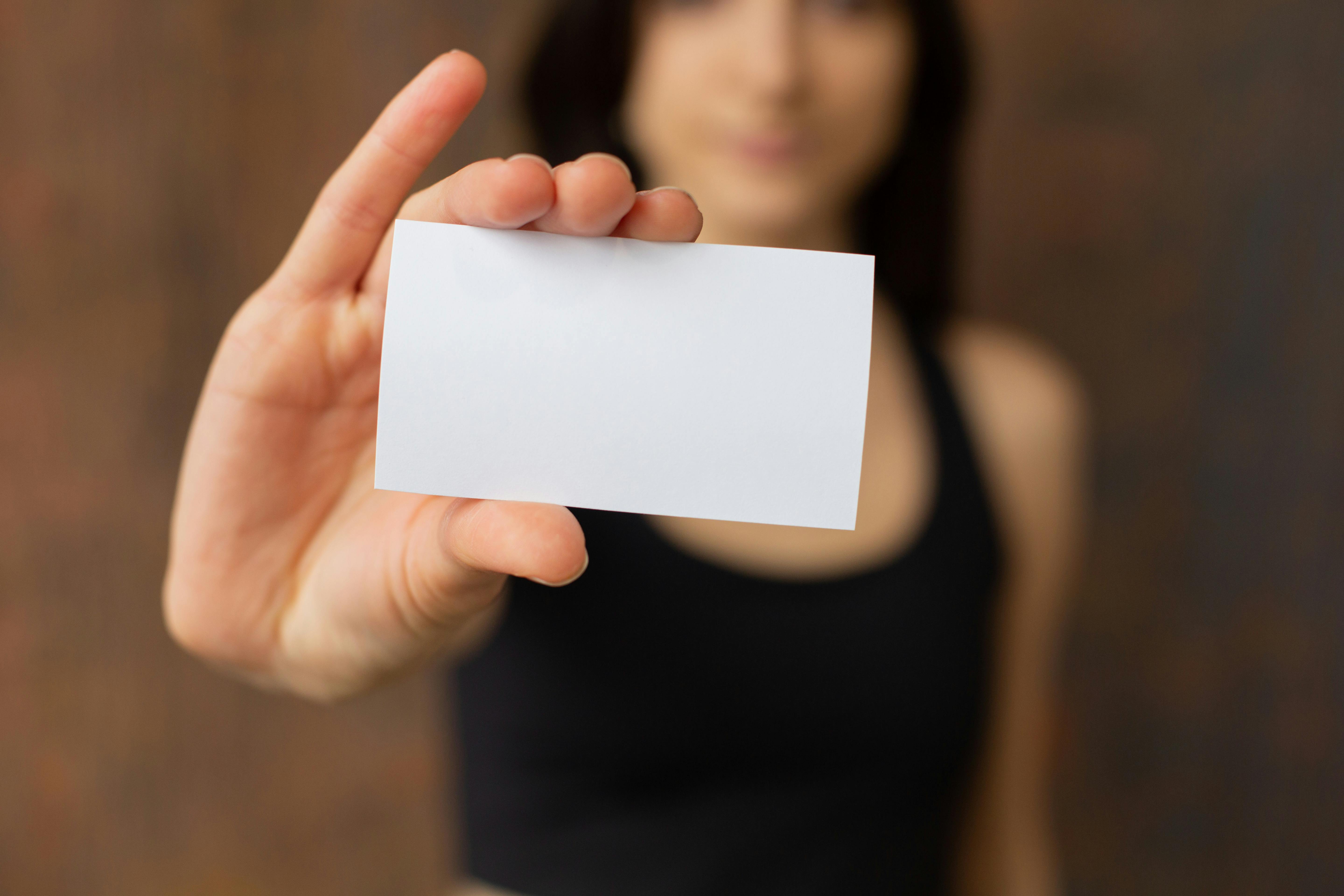 A woman holding a business card | Source: Pexels