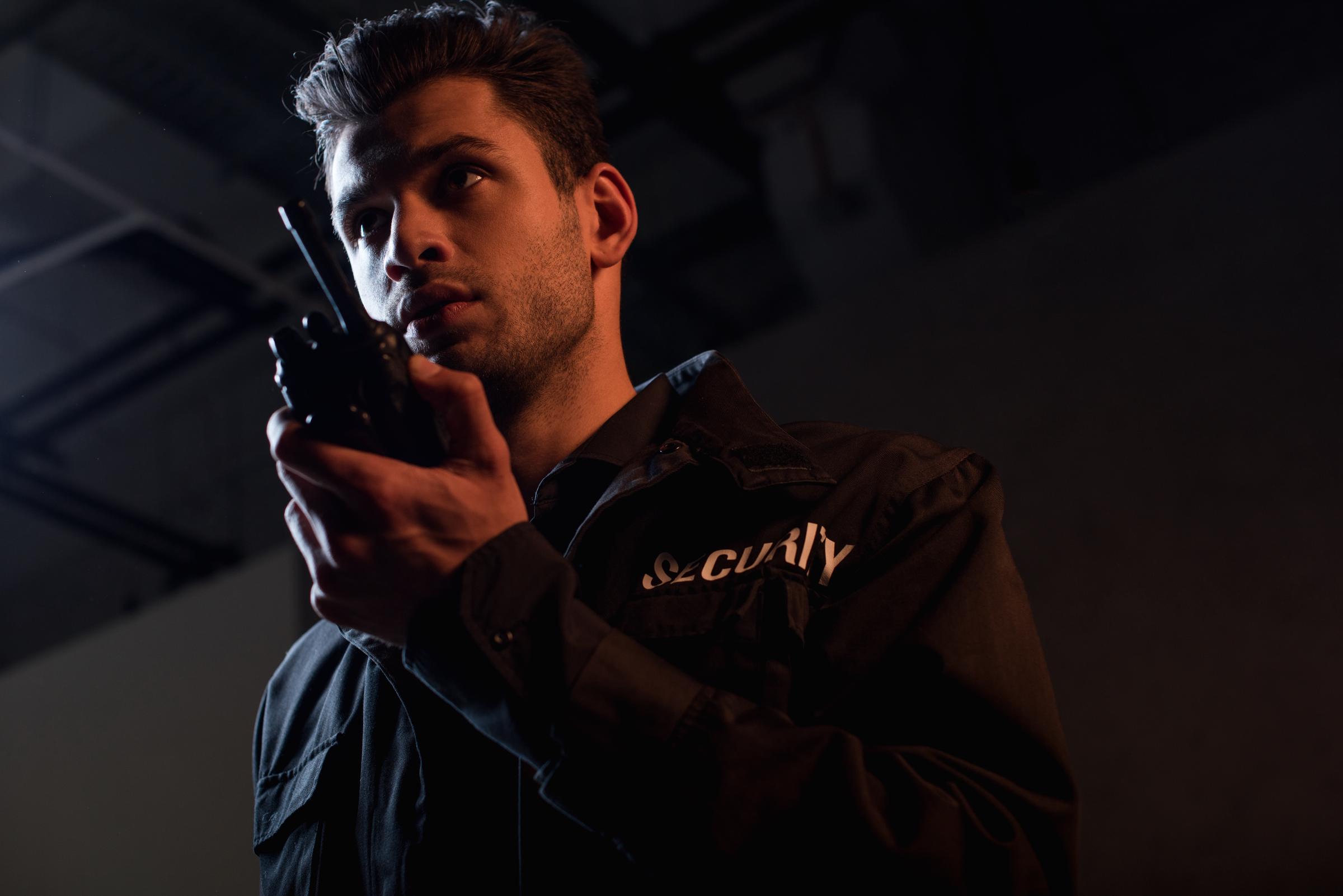 Security guard using a walkie talkie | Source: Shutterstock