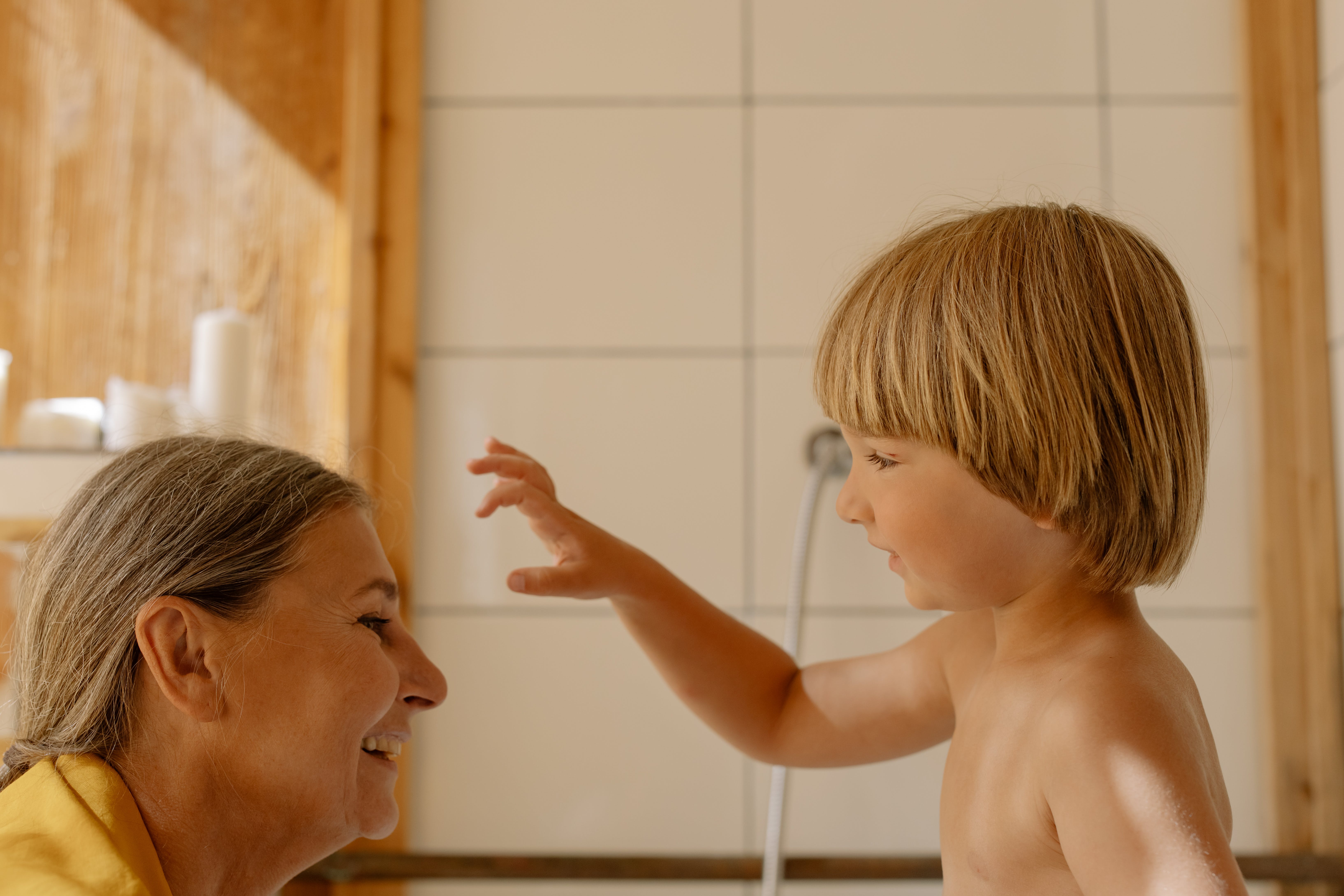 A woman bathing her grandson | Source: Pexels