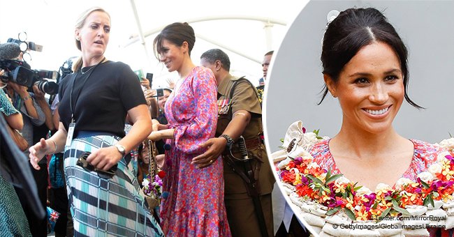 Worried Meghan Markle is rushed out of a crowded market after she whispers to her security for help