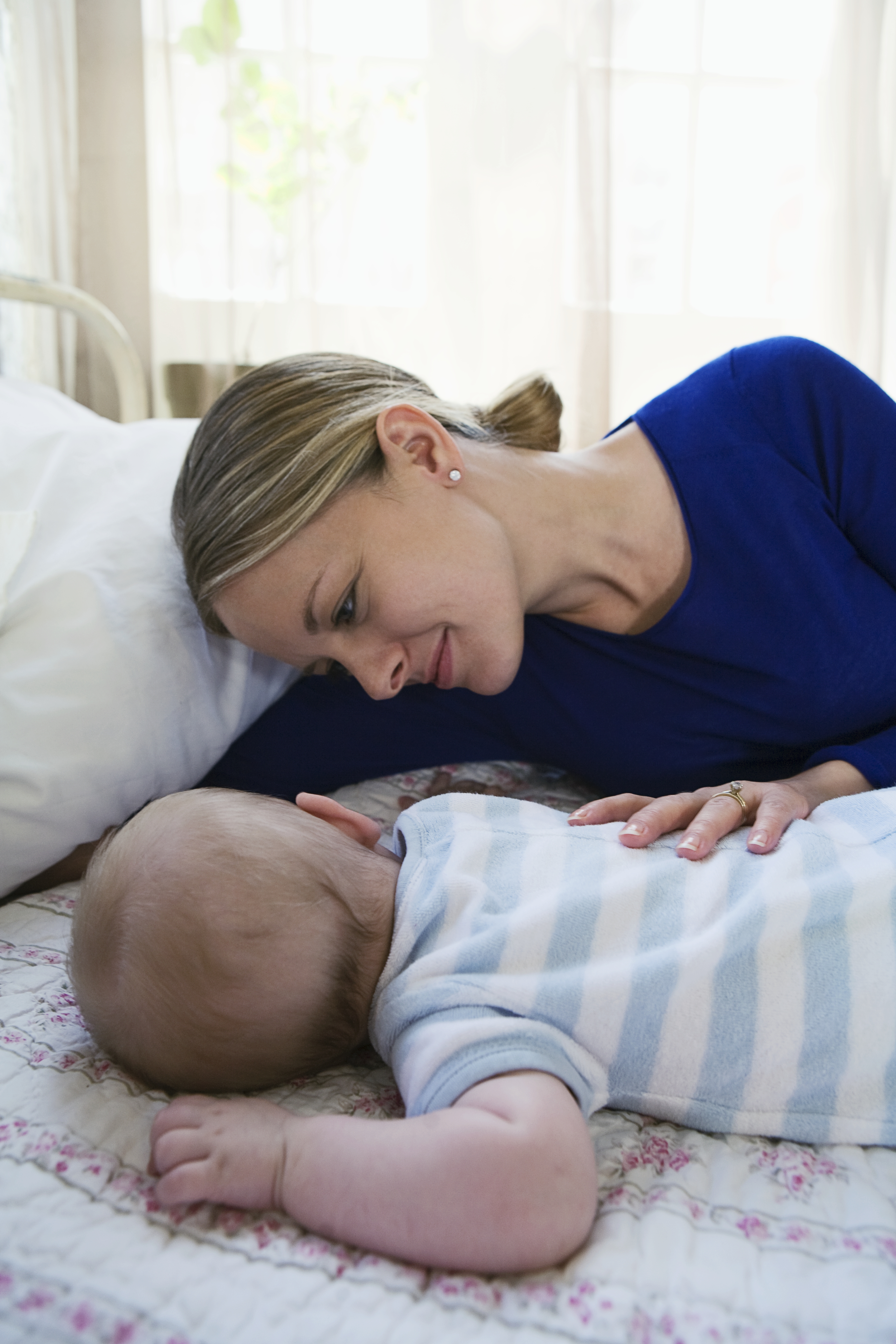 A woman watching her baby sleep | Source: Getty Images