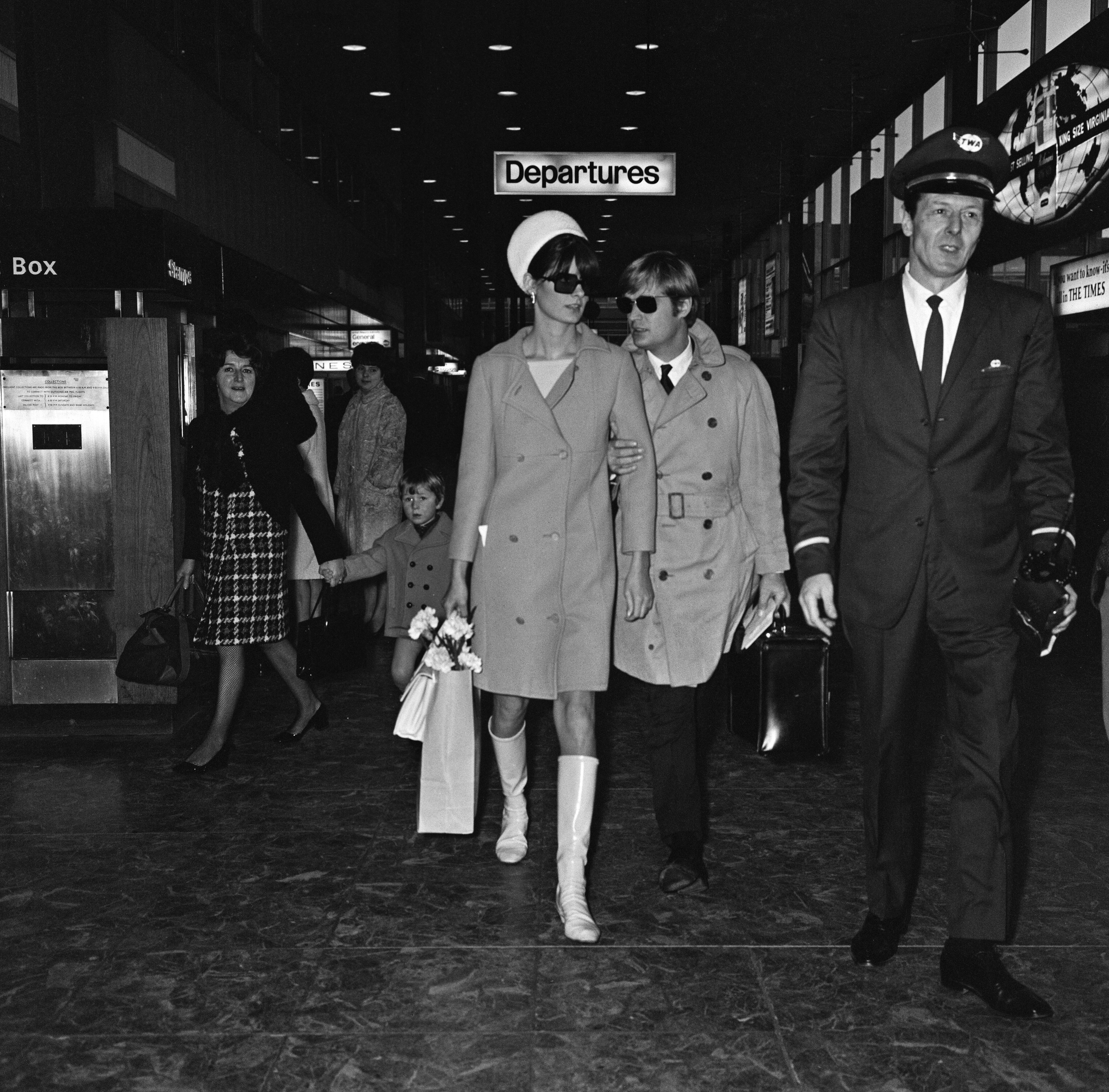 Actor David McCallum, one of the stars of the TV show 'The Man from U.N.C.L.E.' leaving Heathrow Airport for New York with his wife Katherine Carpenter, 18th January 1968 | Source: Getty Images 