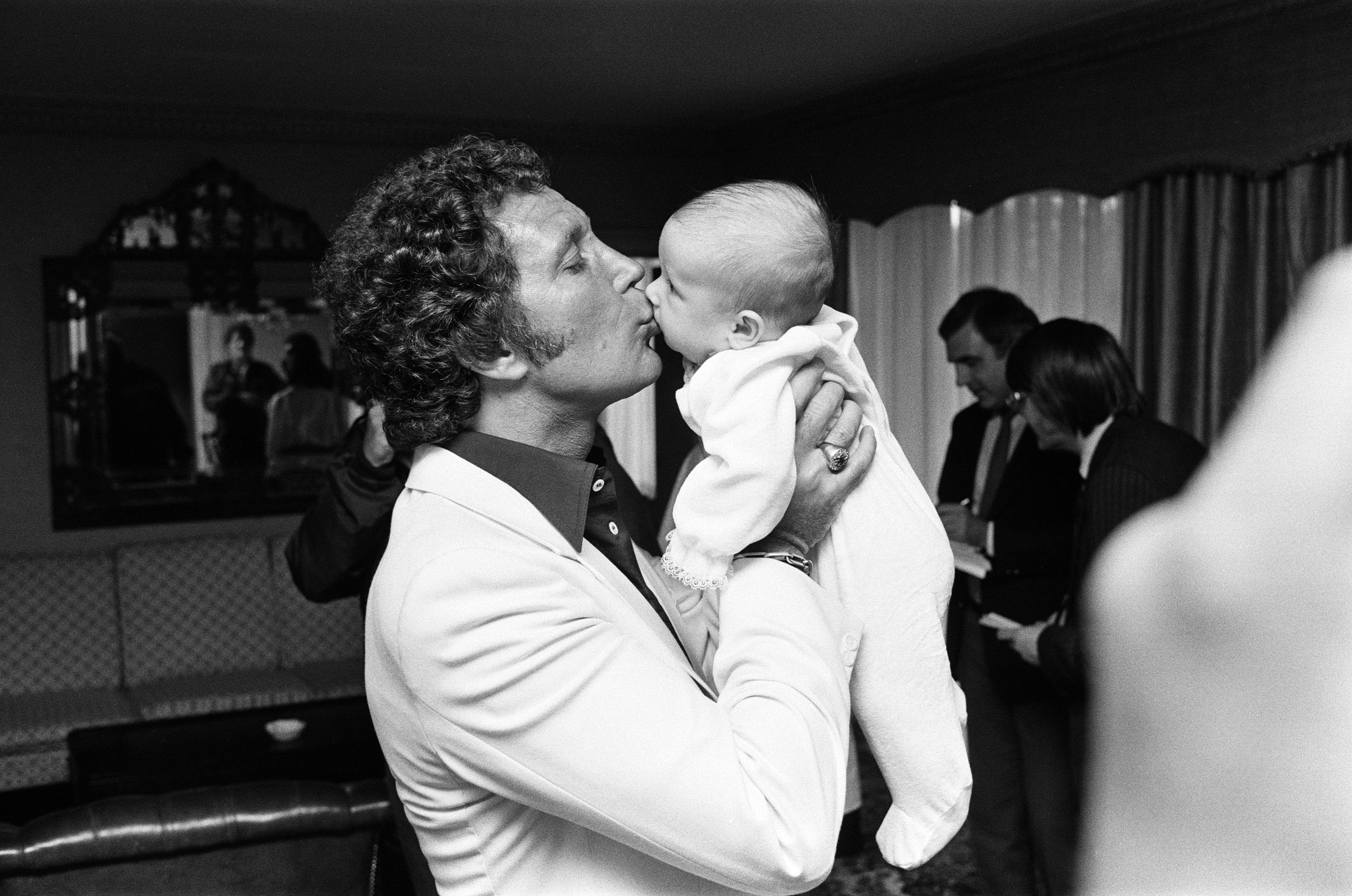 Tom Jones kissing his grandson Alexander in London on September 3, 1983 | Source: Getty Images