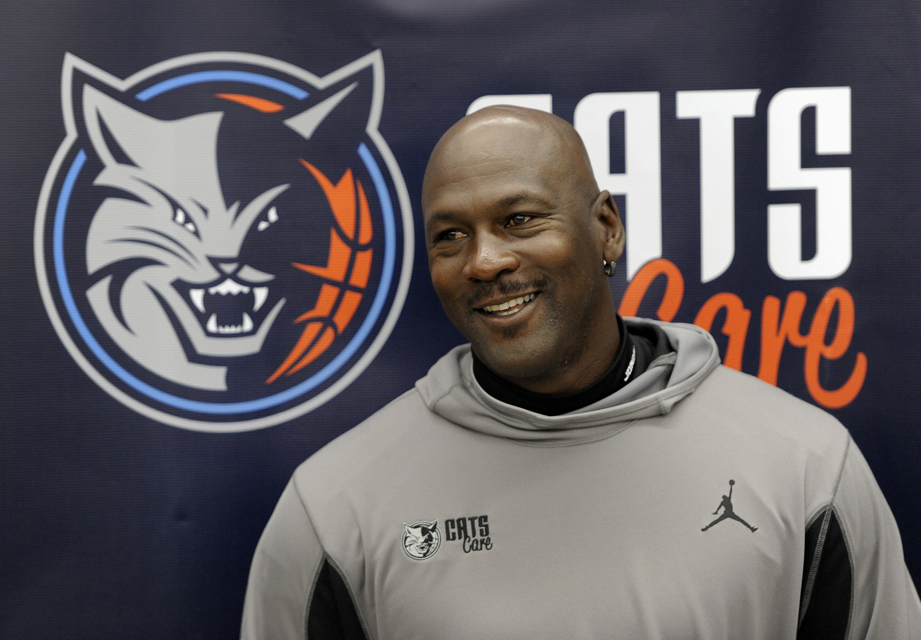 Charlotte Bobcats team owner Michael Jordan smiles during a press conference at West Charlotte High School on Thursday, March 21, 2013. | Source: Getty Images