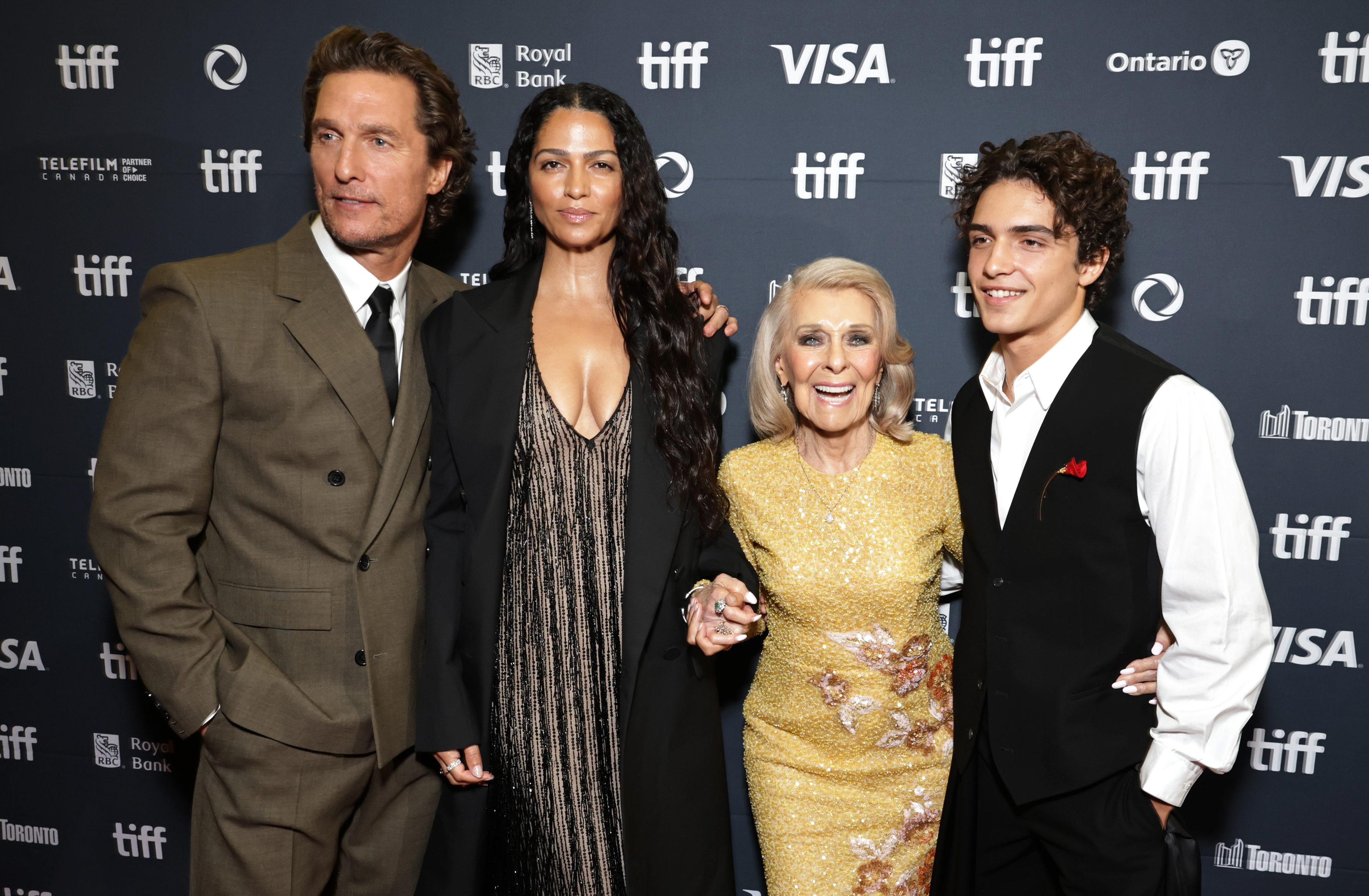 Three generations, one red carpet — Levi beams beside his parents and grandmother Kay at the TIFF premiere of The Lost Bus on September 5, 2025.