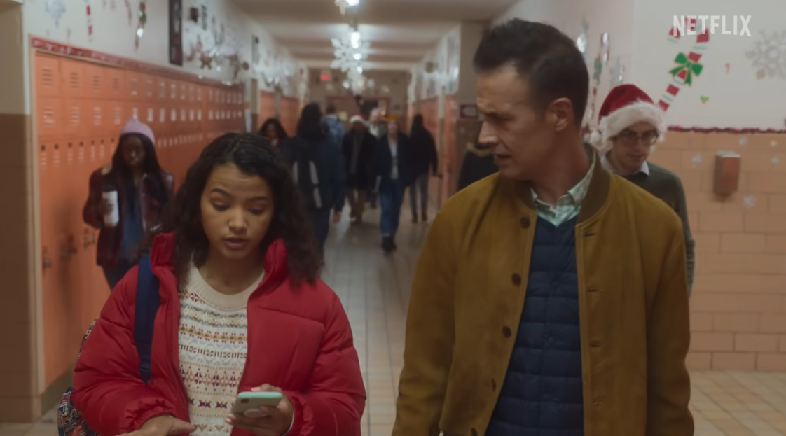 Freddie Prinze Jr. and Deja Monique Cruz walk inside a school hallway in the holiday film "Christmas with You," posted on October 19, 2022 | Source: YouTube/Netflix"