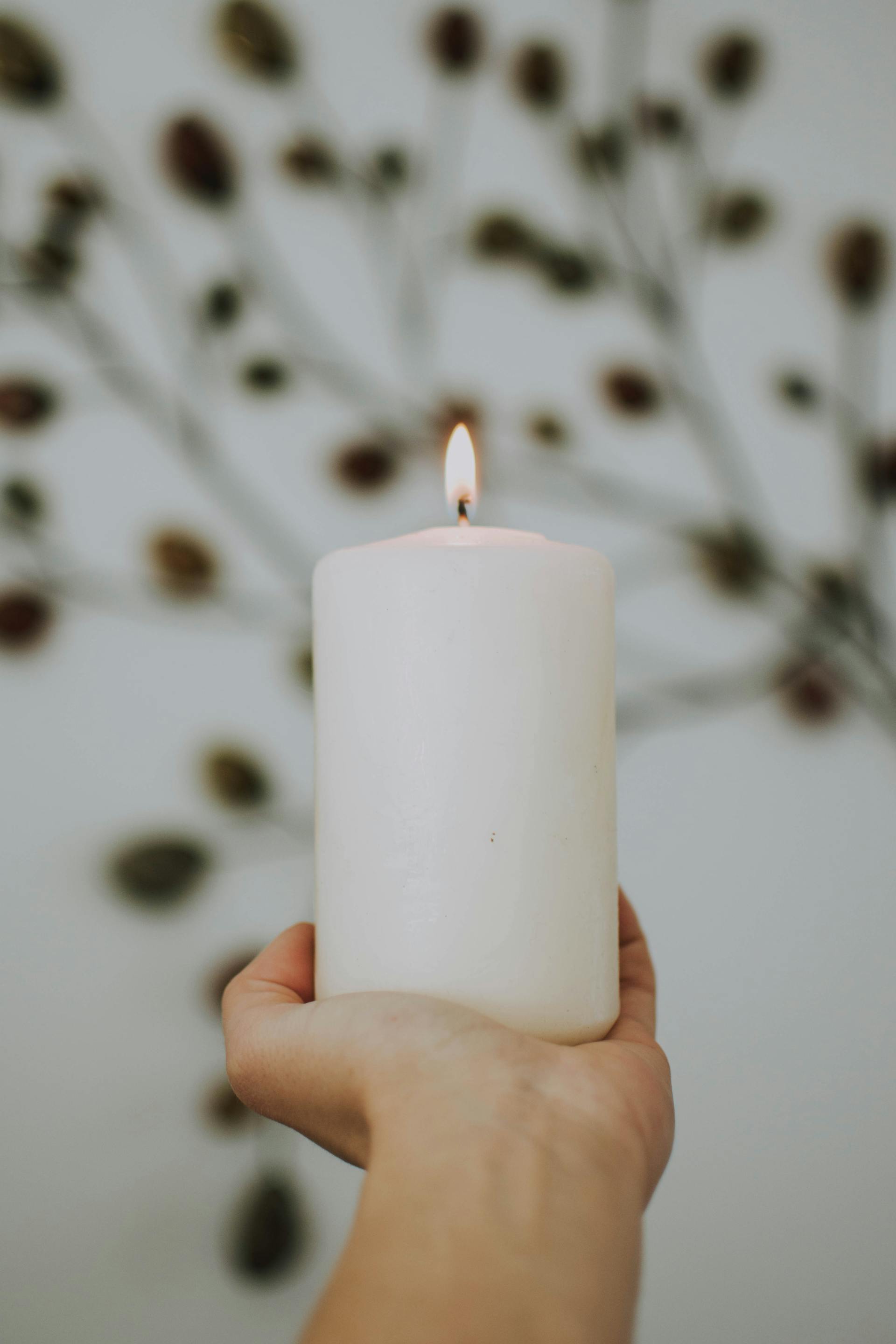 A person holding a lit candle | Source: Pexels