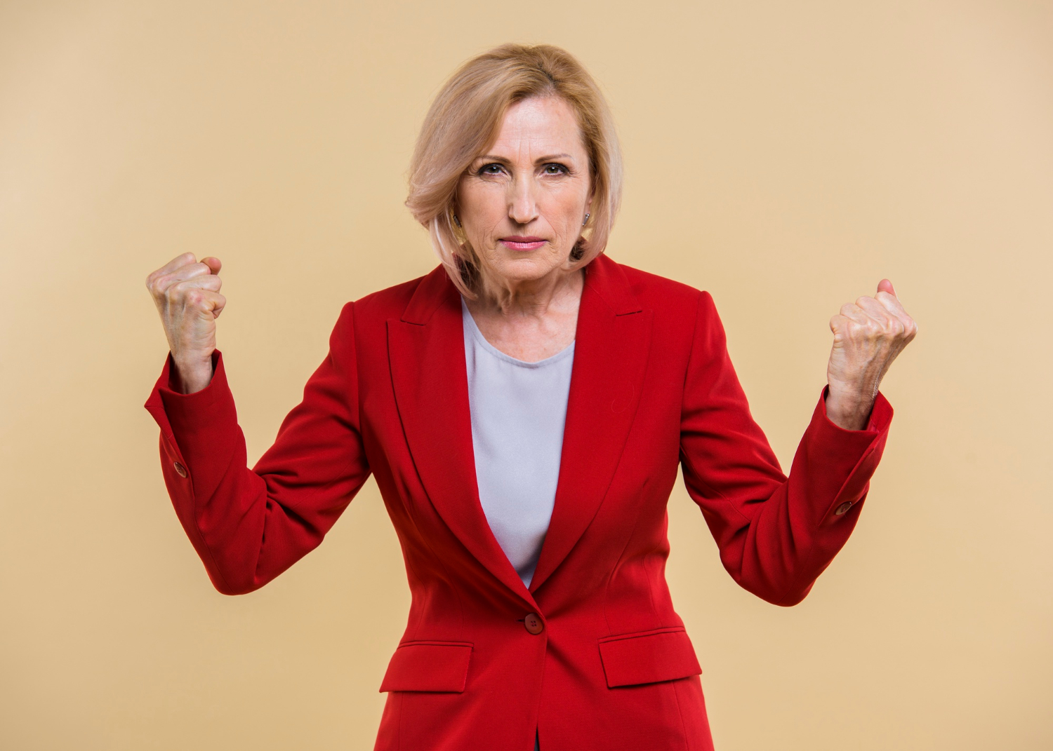 A furious senior woman with her fists clenched | Source: Freepik