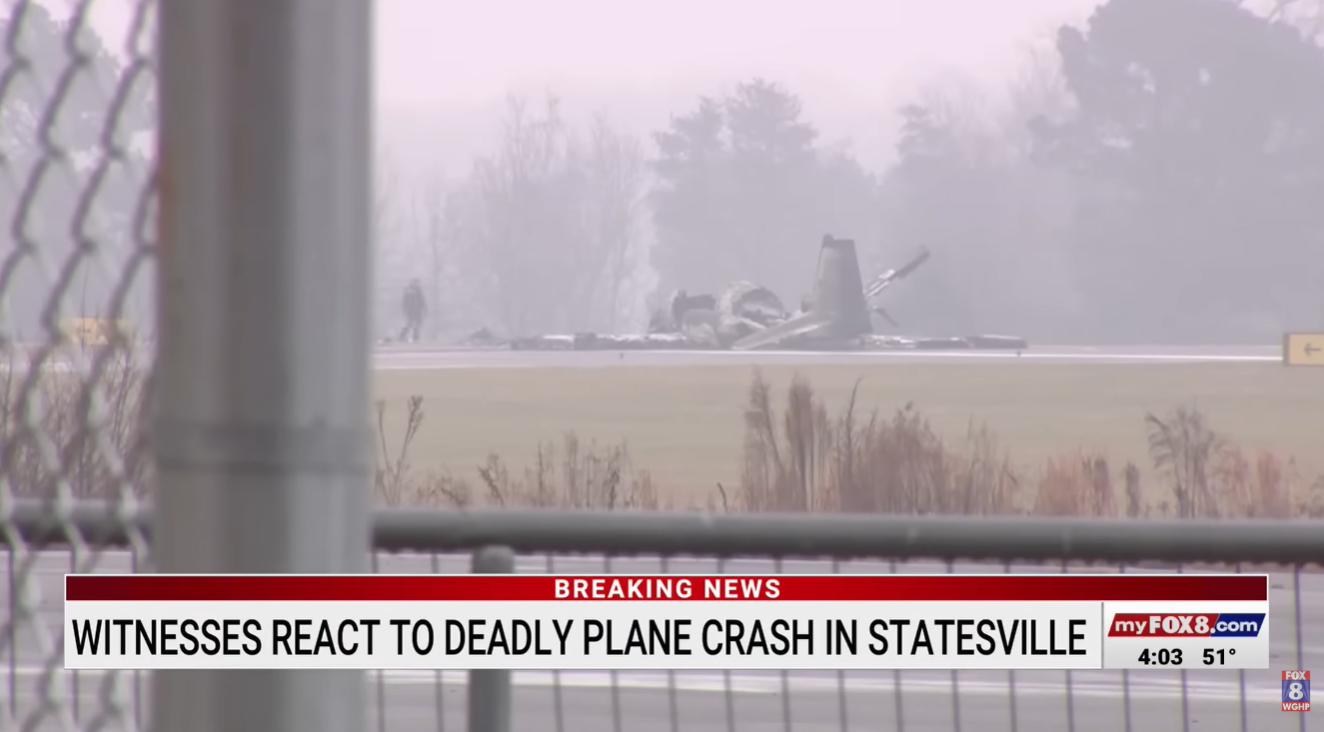 Wreckage of the plane visible on the runway in Statesville, North Carolina | Source: YouTube/myfox8