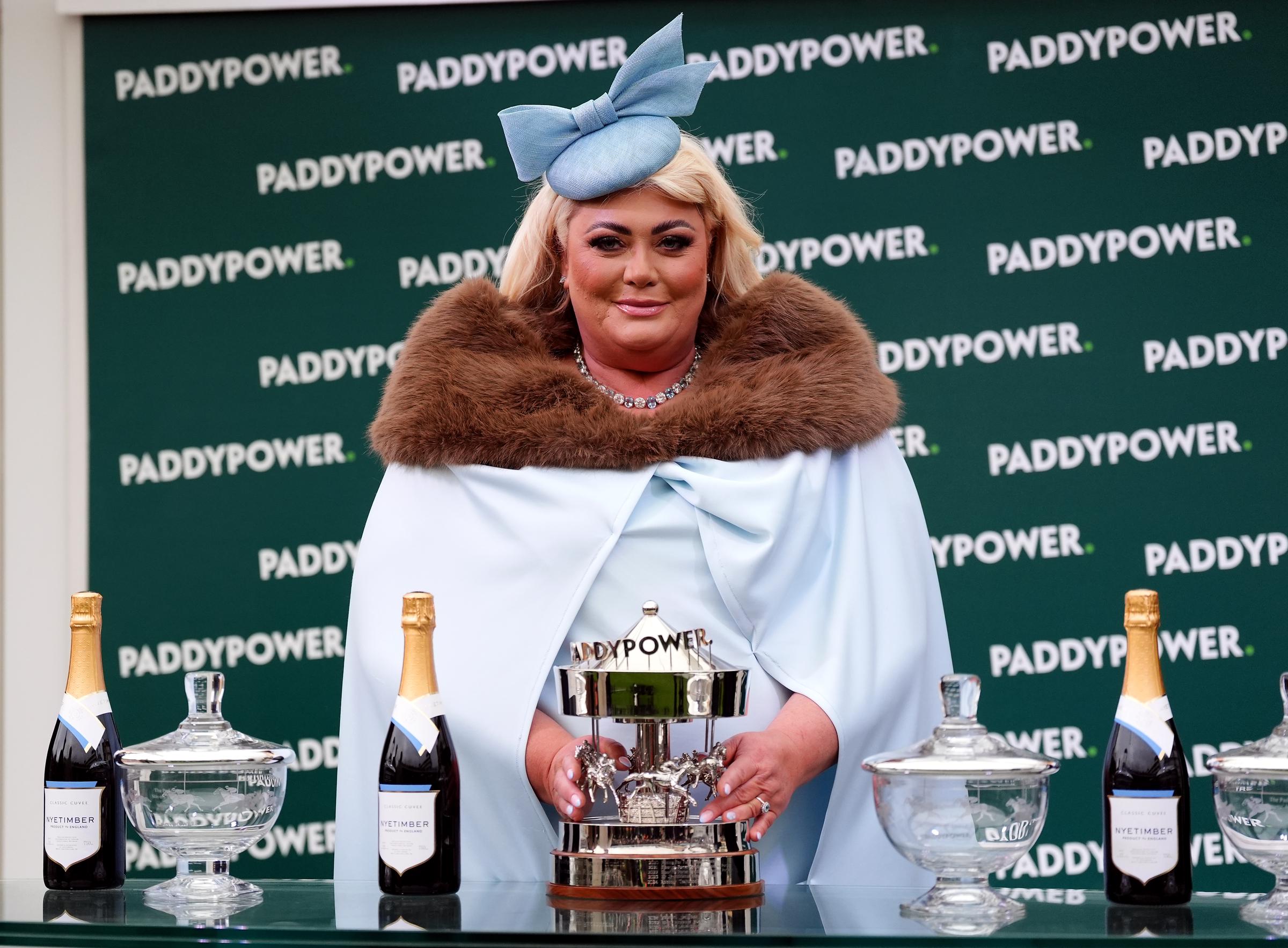 Gemma Collins took centre stage during the trophy presentations for the Paddy Power Stayers' Hurdle on day three of the 2025 Cheltenham Festival on March 13. Dressed in a dramatic powder blue cape with a faux fur collar and matching bow fascinator, she brought vintage glamour to the winner's enclosure as she posed proudly with the trophy.