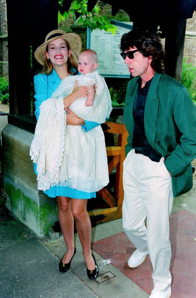 Jerry Hall and Mick Jagger with their daughter Georgia May Jagger during her christening at Saint Andrew's church, Richmond 1992. | Source: Getty Images